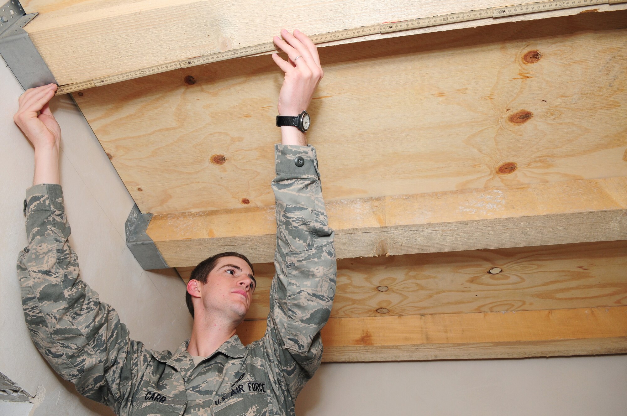 SPANGDAHLEM AIR BASE, Germany – Airman 1st Class Trent Carr, 52nd Civil Engineer Squadron structural apprentice, takes a measurement to determine the length of sheetrock to be cut for a remodeling project here June 21. The structures flight within the 52nd CES is responsible for all emergency, urgent and routine work orders for carpentry, locksmithing, masonry and metalwork on Spangdahlem Air Base and 18 geographically separated units. (U.S. Air Force photo/Airman 1st Class Matthew B. Fredericks)
