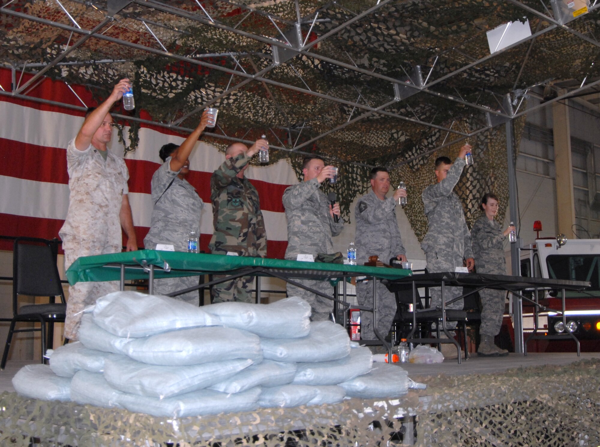 GOODFELLOW AIR FORCE BASE, Texas—Senior Enlisted representatives from the Marine Corps, Army and Air Force, as well as the most junior servicemember present, offer a toast to Prisoners of War/Missing in Action servicemembers using only water during the Joint Enlisted Combat Dining In June 18.  More than 300 enlisted servicemembers attended the event. (U.S. Air Force photo/Airman 1st Class Jessica Keith)