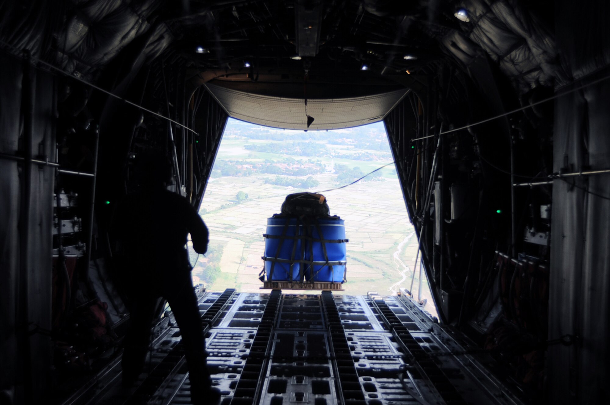 GORDA DROP ZONE, Indonesia -- A Container Delivery System pallet is released from a C-130 Hercules with the 36th Airlift Squadron from Yokota Air Base, Japan, during Exercise Cope West 11 over the Gorda drop zone, Indonesia, June 21, 2011. Three Yokota C-130 aircraft and more than 70 Yokota airmen, as well as one Indonesian Air Force C-130 participate in this week-long bilateral field training exercise which is designed to enhance the readiness and combined interoperability between the U.S. and Indonesian Air Forces. (U.S. Air Force photo/Capt. Raymond Geoffroy)