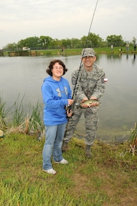 Rachel, (left) a senior at Lincoln Northstar High school enrolled in the Functional Community Reference program, and her fishing buddy Master Sgt. Aaron Aulner, 155th Air Refueling Wing Prime Ribs manager, show off a fish they caught on May 20, 2011 during the annual "Gators Gone Fishin". This is the second year Rachel and Master Sgt. Aulner paired together to catch fish and enjoy the event. (Nebraska Air National Guard photo by Senior Master Sgt. Lee Straube)