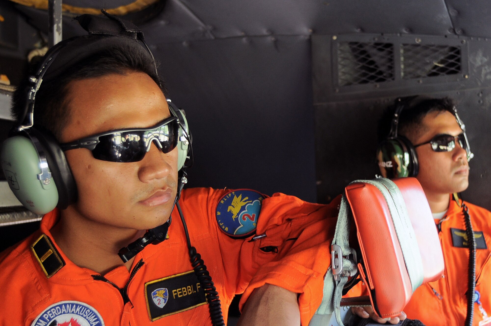 HALIM AIR BASE, Indonesia -- Two Indonesian Air Force pilots observe as an aircrew with the 36th Airlift Squadron from Yokota Air Base, Japan, prepares for an airdrop mission during Exercise Cope West 11 at Halim Air Base, Indonesia, June 21, 2011. During the exercise, Airmen observe and exchange tactics, techniques and procedures to further strengthen the close partnership between the U.S. and Indonesian Air Forces. (U.S. Air Force photo/Capt. Raymond Geoffroy)