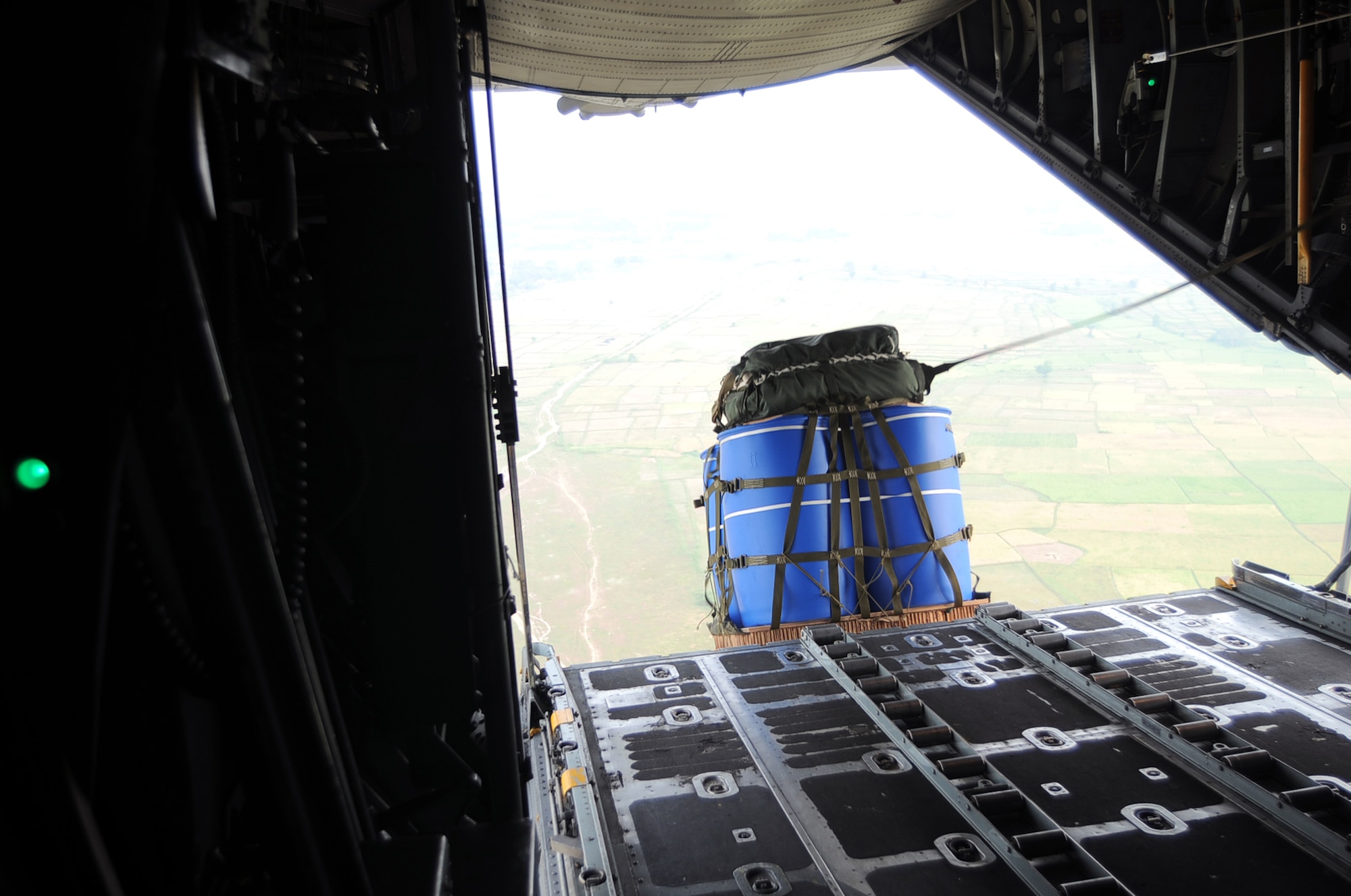 GORDA DROP ZONE, Indonesia -- A Container Delivery System pallet is released from a C-130 Hercules with the 36th Airlift Squadron from Yokota Air Base, Japan, during Exercise Cope West 11 over the Gorda drop zone, Indonesia, June 20, 2011. Three Yokota C-130 aircraft and more than 70 Yokota airmen, as well as one Indonesian Air Force C-130 participate in this week-long bilateral field training exercise which is designed to enhance the readiness and combined interoperability between the U.S. and Indonesian Air Forces. (U.S. Air Force photo/Capt. Raymond Geoffroy)