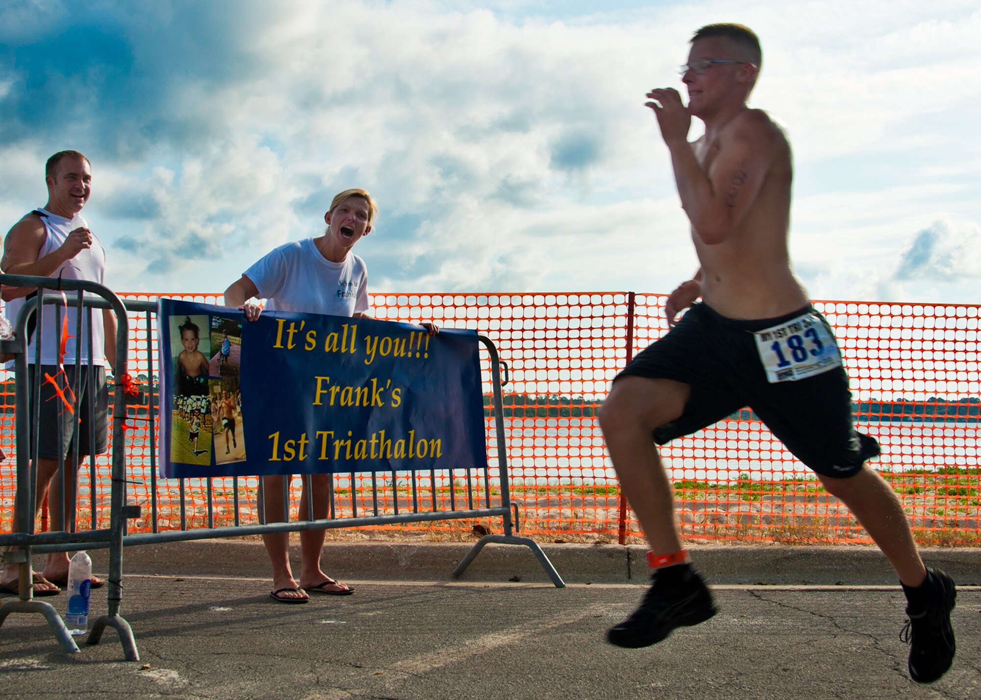 Dina Lasch cheers on her son Frank as he sprints toward the finish of this year’s “My First Tri” triathlon at Eglin Air Force Base Fla., June 18.  Almost 350 people of all ages “tried” at the 12th annual event.  The triathlon consists of a 200-meter swim, eight-mile bike ride, then a 2.5-mile run.  Lasch was 65th among first-time competitors finishing at one hour and six minutes.  (U.S. Air Force photo/Samuel King Jr.)