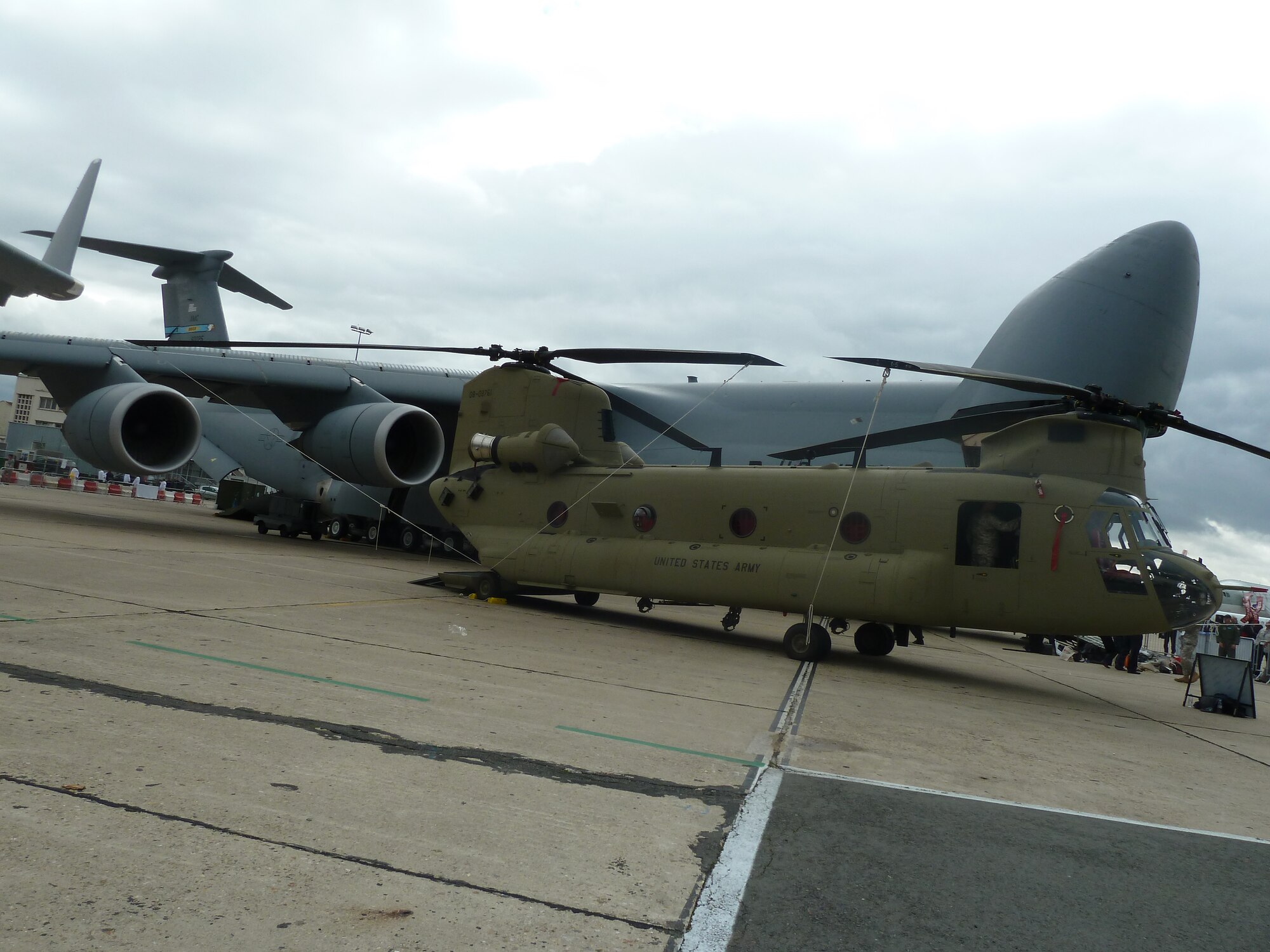 An Army CH-47F Chinook and the Air Force C-5M Super Galaxy are two of the 11 U.S. aircraft on display at the 49th International Paris Air Show, Le Bourget Airport, France, June 20-26. The C-5M transported the Chinook to the show and both aircraft are making a first appearance at the event. (U.S. Air Force photo/Tech. Sgt. Francesca Popp)