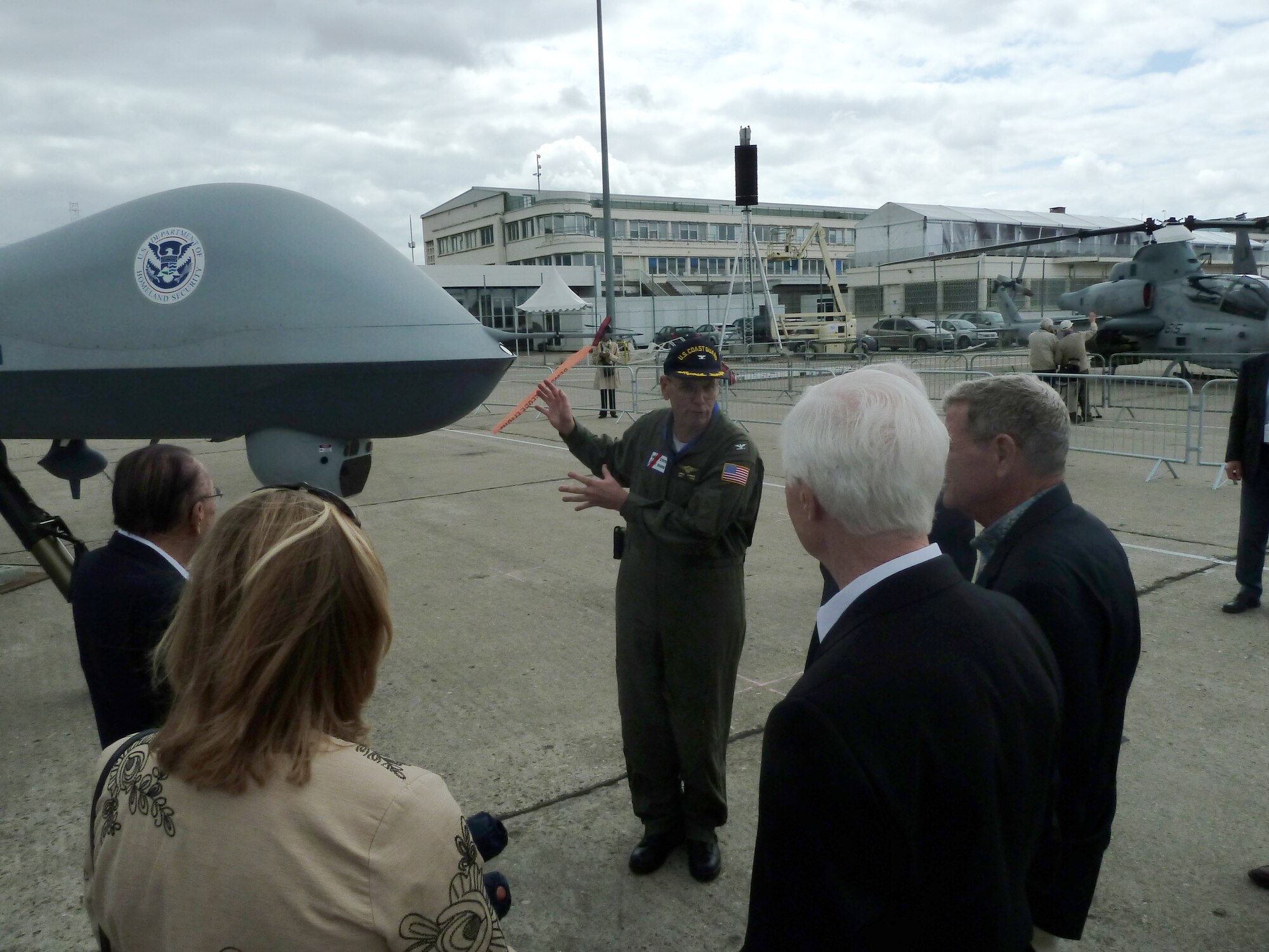 U.S. Coast Guard Capt. James Sommer explains the role of the MQ-9 Predator B (Guardian) unmanned aerial system to a Congressional Delegation at the 49th International Pars Air Show, Le Bourget Airport , France. The MQ-9 is operated by the U.S. Customs and Border Protection and the U.S. Coast Guard for the Department of Homeland Security, and is making its first appearance at the Paris Air Show. (U.S. Air Force photo/Tech. Sgt. Francesca Popp)