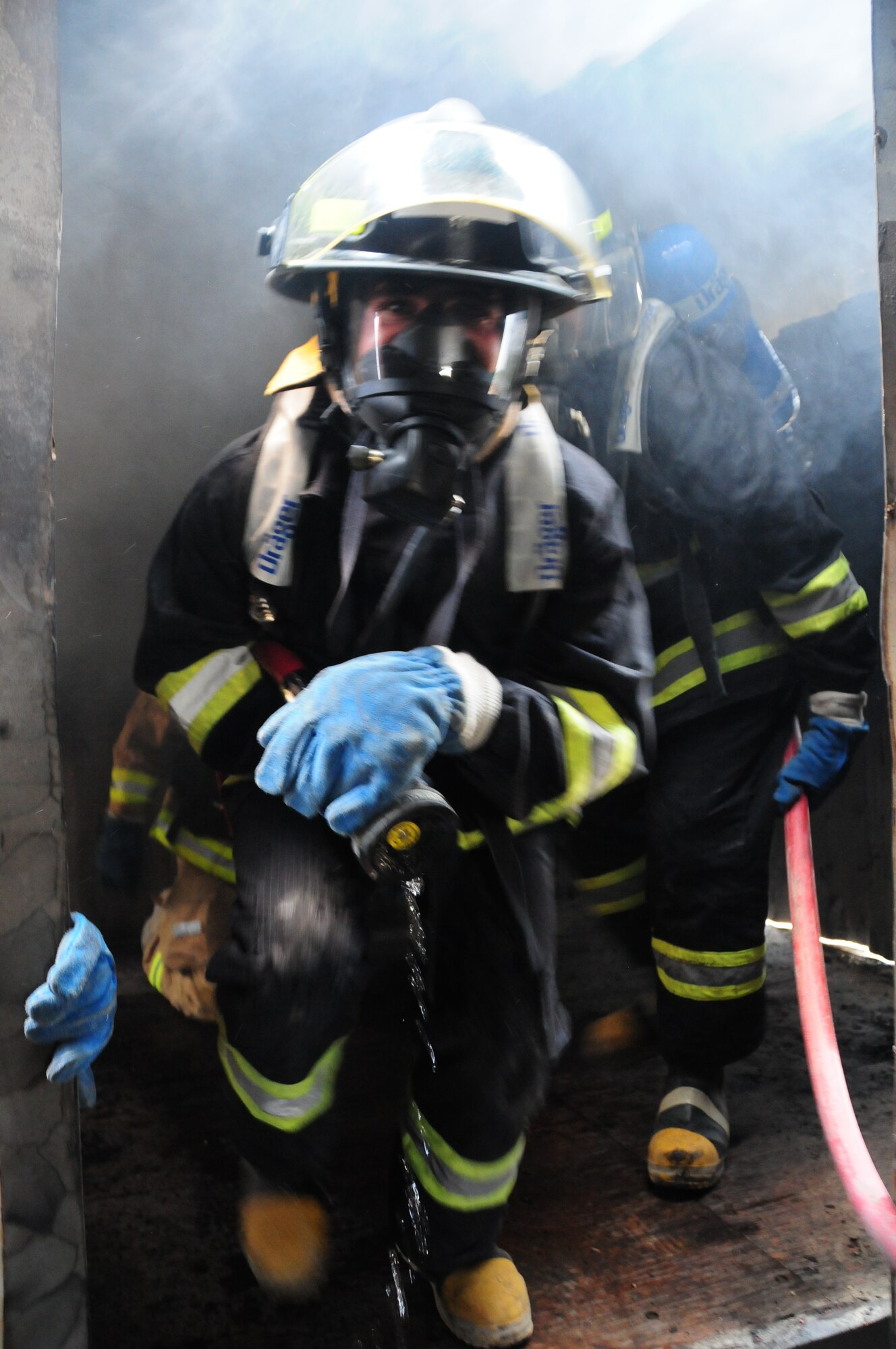 KABUL, Afghanistan -- A firefighter from the Afghan Air Force, rushes into a controlled burn exercise while conducting training at the Kabul International Airport, June 21, 2011.  Coalition forces work shoulder-to-shoulder with the AAF in an advisory role. (U.S. Air Force photo by Senior Airman Amber Williams)