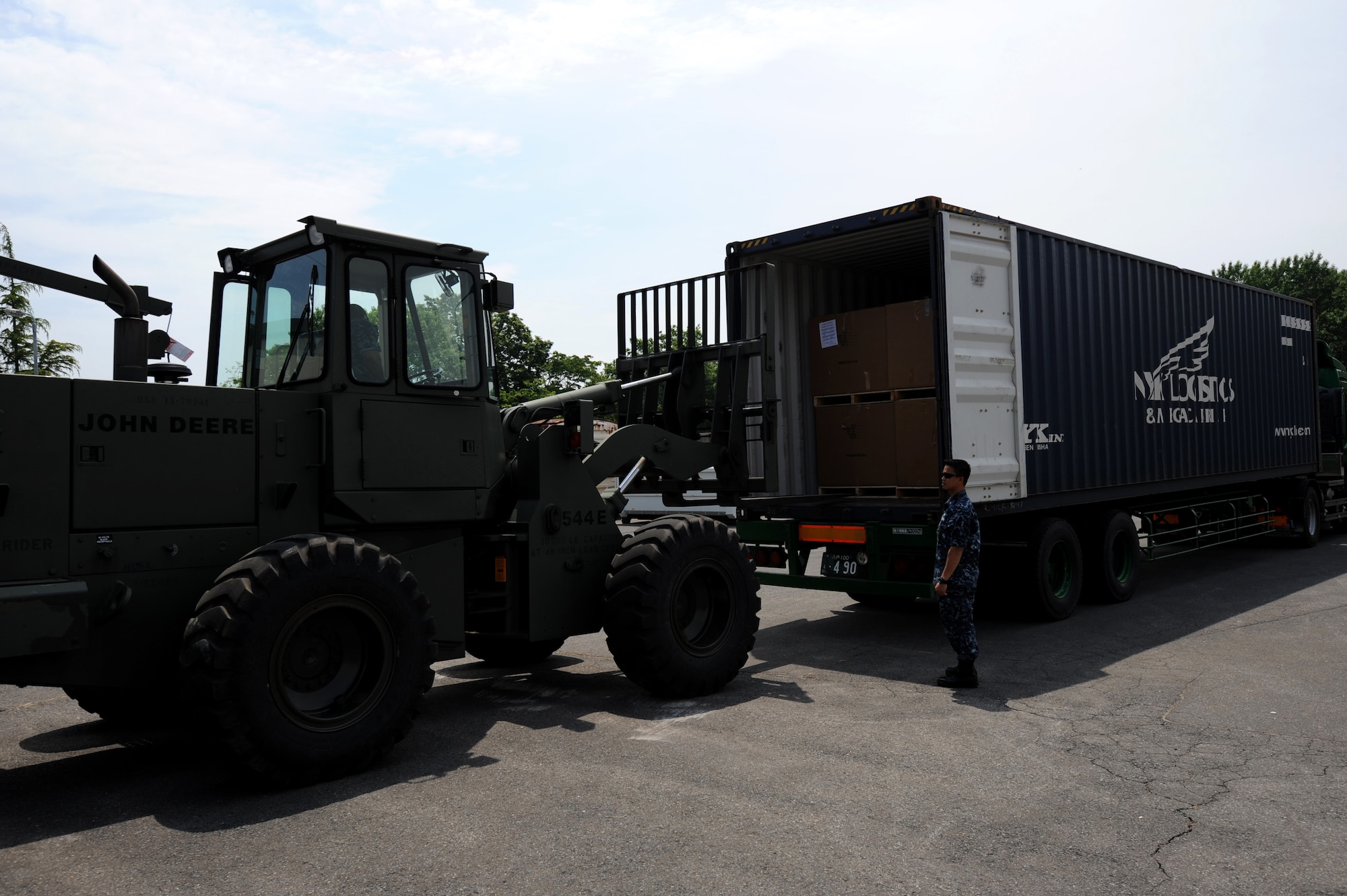 MISAWA AIR BASE, Japan -- U.S. Navy Petty Officer Ronnie Santos guides a forklift as it unloads humanitarian assistance at a warehouse here June 21.  Members of the Misawa community worked with "The Ron and Don Show," a Seattle-based radio program, to coordinate the collection, shipping and distribution of more than 90,000 pounds of goods from the U.S. to help Japanese orphanages affected by the March 2011 earthquake and tsunami.  (U.S. Air Force photo/ Staff Sgt. April Quintanilla)
