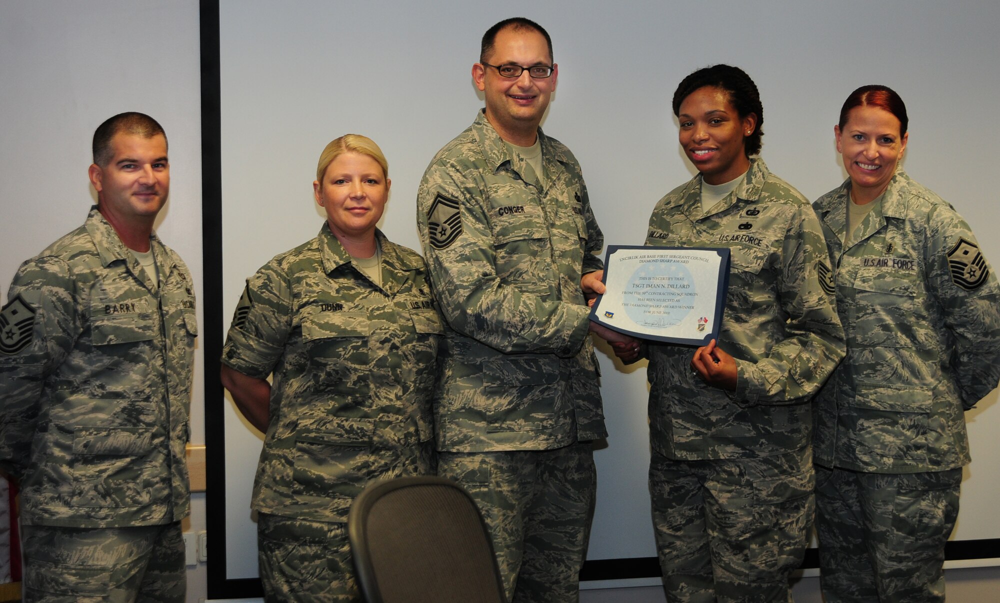 Tech. Sgt. Iman Dillard, 39th Contracting Squadron contract administrator, receives the Diamond Sharp award from members of the Incirlik First Sergeant’s Council June 7, 2011, at Incirlik Air Base, Turkey. The award is used to recognize Airmen who have distinguished themselves through outstanding professionalism, performance and display of the Air Force core values. (U.S. Air Force photo by Senior Airman Anthony Sanchelli/Released)