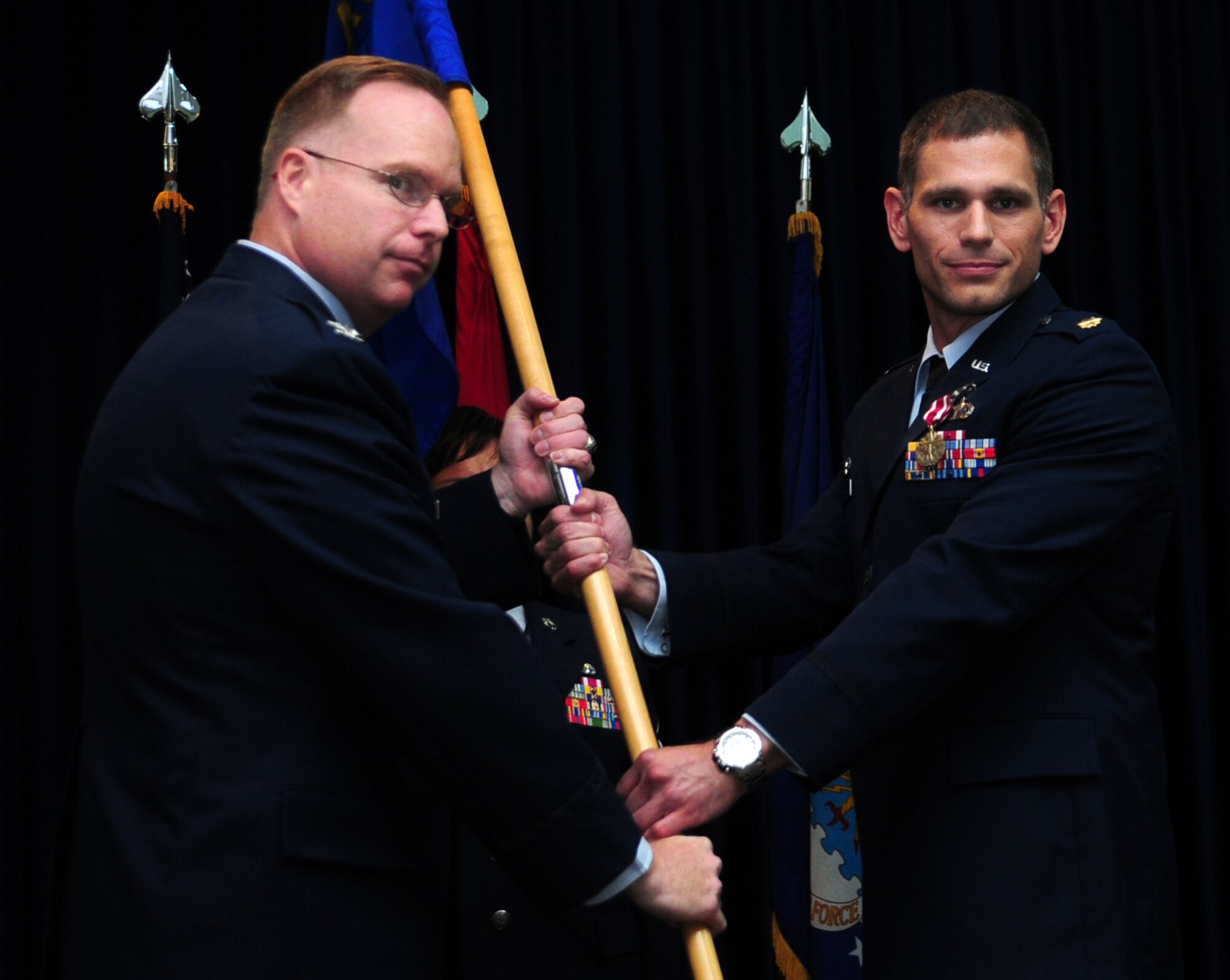 Col. Eric Beene (left), 39th Air Base Wing commander, receives the guidon from Maj. Joseph Schaefer, outgoing 39th Comptroller Squadron commander, during the 39th CPTS change-of-command ceremony, June 14, 2011, at Incirlik Air Base, Turkey.  (U.S. Air Force photo by Senior Airman Anthony Sanchelli/Released)