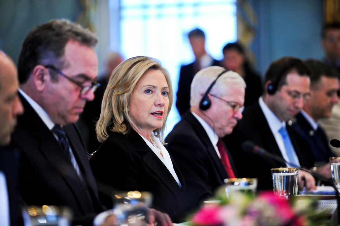 U.S. Secretary Of State Hillary Rodham Clinton, Center Left, Addresses ...