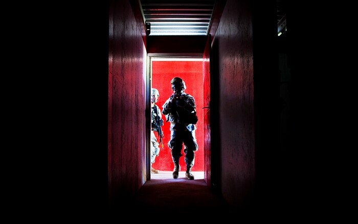 Army Sgt. Peter Terlaje, a team leader with Echo Company, 100th Battalion, 442nd Infantry Regiment, breaches the entrance of the modular armored tactical combat house, or “shoot house,” while clearing the building at the Kaneohe Bay Range Training Facility on Marine Corps Base Hawaii, June 21, 2011. The training evolution was part of the reserve infantry battalion’s annual training package conducted both here and on Schofield Barracks from June 13 to June 30.