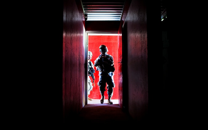 Army Sgt. Peter Terlaje, a team leader with Echo Company, 100th Battalion, 442nd Infantry Regiment, breaches the entrance of the modular armored tactical combat house, or “shoot house,” while clearing the building at the Kaneohe Bay Range Training Facility on Marine Corps Base Hawaii, June 21, 2011. The training evolution was part of the reserve infantry battalion’s annual training package conducted both here and on Schofield Barracks from June 13 to June 30.