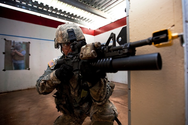 Army Spc. Johnny Cruz, a grenadier with Echo Company, 100th Battalion, 442nd Infantry Regiment, provides security while clearing rooms in the modular armored tactical combat house, or “shoot house,” at the Kaneohe Bay Range Training Facility on Marine Corps Base Hawaii, June 21, 2011. The training evolution was part of the reserve infantry battalion’s annual training package conducted both here and on Schofield Barracks from June 13 to June 30.
