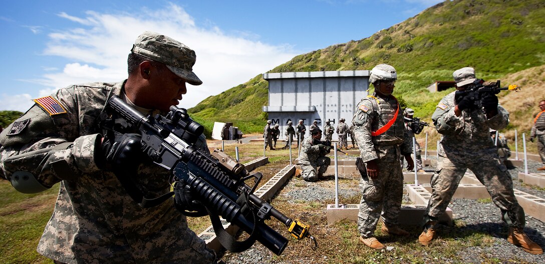 Army Spc. Daniel Toves, a rifleman with Echo Company, 100th Battalion, 442nd Infantry Regiment, practices room clearing in a “glass house,” an open maze of cinder blocks positioned to mock the layout of a building, in preparation for clearing the modular armored tactical combat house, or “shoot house,” at the Kaneohe Bay Range Training Facility on Marine Corps Base Hawaii, June 21, 2011. The training evolution was part of the reserve infantry battalion’s annual training package conducted both here and on Schofield Barracks from June 13 to June 30.