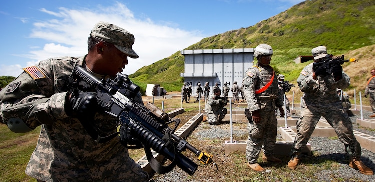 Army Spc. Daniel Toves, a rifleman with Echo Company, 100th Battalion, 442nd Infantry Regiment, practices room clearing in a “glass house,” an open maze of cinder blocks positioned to mock the layout of a building, in preparation for clearing the modular armored tactical combat house, or “shoot house,” at the Kaneohe Bay Range Training Facility on Marine Corps Base Hawaii, June 21, 2011. The training evolution was part of the reserve infantry battalion’s annual training package conducted both here and on Schofield Barracks from June 13 to June 30.