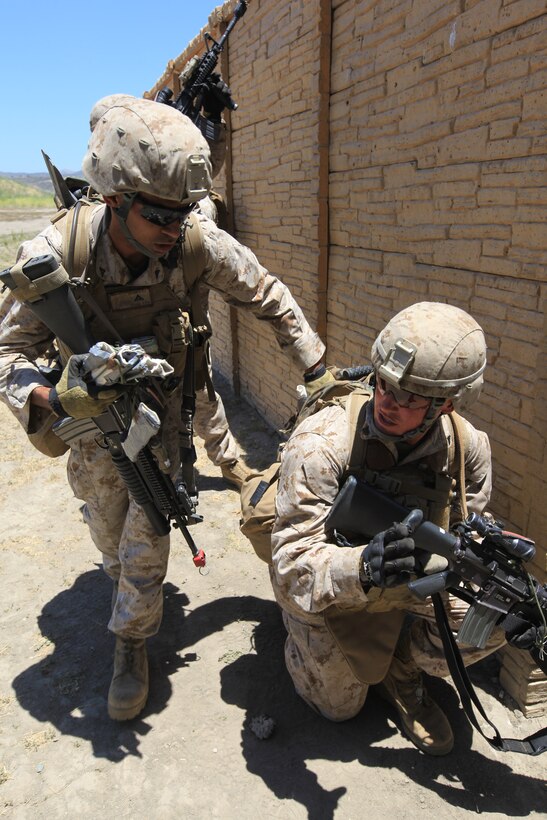 Marines and sailors participate in a raid exercise here June 21. The service members serve with Company K, one of three rifle companies in Battalion Landing Team 3/1, the ground-combat element for the 11th Marine Expeditionary Unit. The unit began a full-scale exercise June 13, its first since becoming a complete Marine air-ground task force in May.