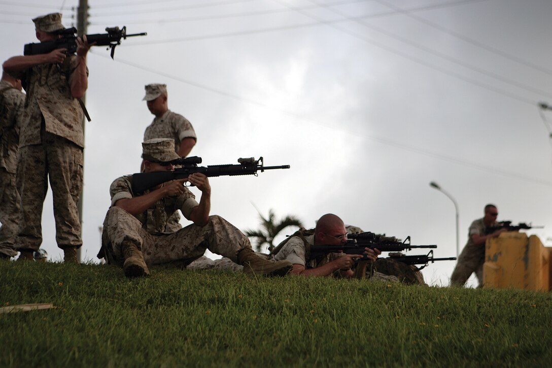 Marines use rifle combat-optic sights attached to their M16A4 and M4 service rifles to practice range estimations during a Combat Hunter course at Camp Hansen June 22. The week-long course is designed to improve identification and observation skills.