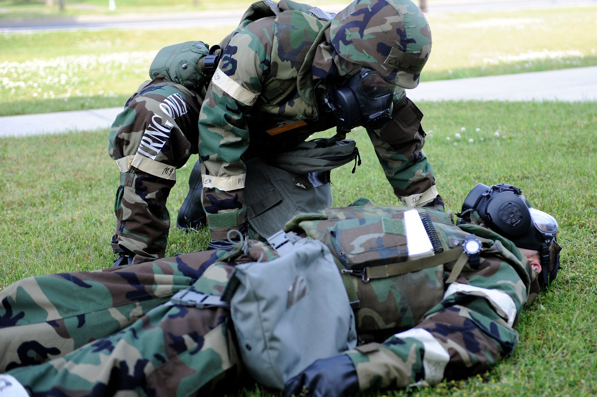 MISAWA AIR BASE, Japan -- Col. Michael Rothstein, 35th Fighter Wing commander, assist a victim of a simulated mortar attack during a training exercise June 22. The wing is engaged in a week-long exercise, simulating a variety of scenarios in a combat environment. (U.S. Air Force photo/Staff Sgt. Marie Brown/Released)
