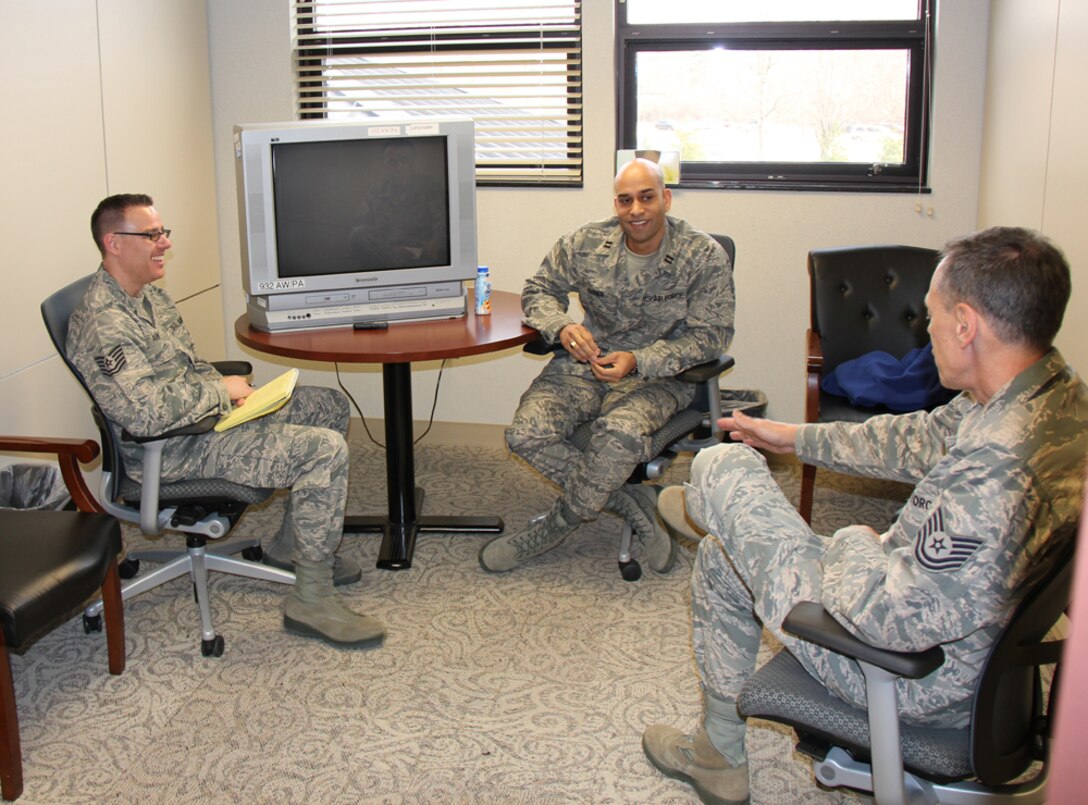 Public affairs specialist Tech. Sgt. Chris Parr listens to Tech. Sgt. Dan Oliver discuss a story idea with a 932nd Airlift Wing member in the interview room next to the public affairs office.  Members are encouraged to share their unique military experiences with the wing.  (Photo submitted by Senior Airman Jessica Davila-Caba)