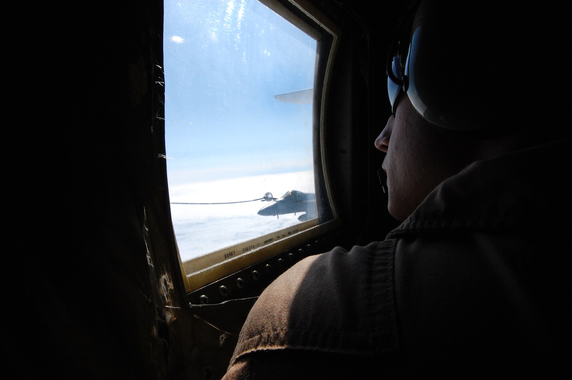 U.S. Marine Corps Sgt. Jimmie Lynch, a load master with the Marine Aerial Transport Squadron (VMGR) 452, Stewart Air National Guard Base, N.Y., observes air-to-air refueling operations during the Northern Edge Premier Joint Training Exercise at the Joint Pacific Alaska Range Complex, June 21. Land-based forces hone their skills in attacking targets at sea during the exercise. (U.S. Air Force photo/Staff Sgt. Lakisha A. Croley)