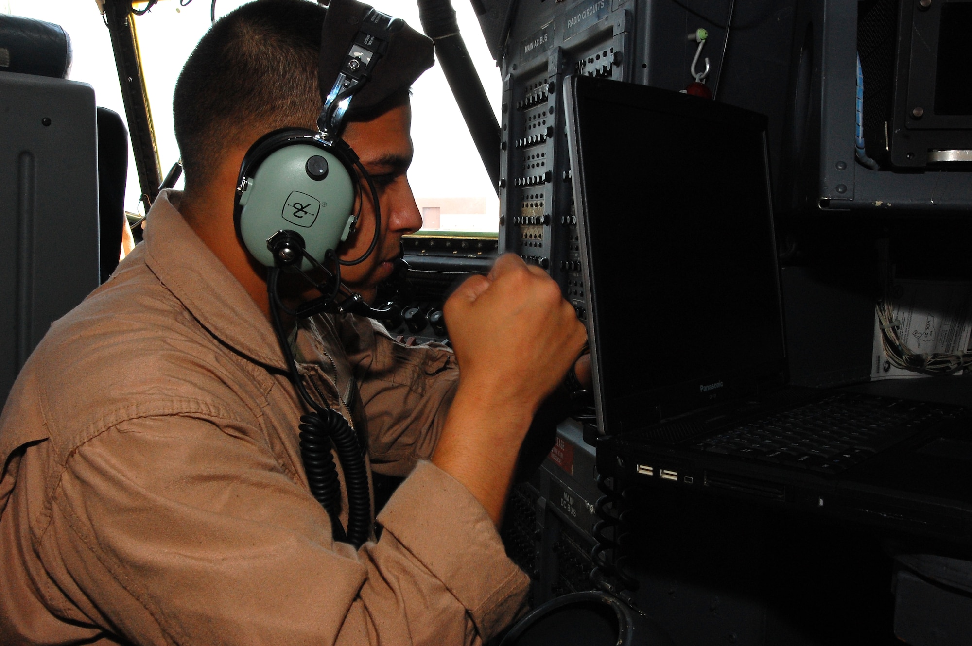 U.S. Marine Corps Sgt. Mark Romero, a navigator with the Marine Aerial Transport Squadron (VMGR) 452, Stewart Air National Guard Base, N.Y., positions a laptop so he can setup the Moving Maps GPS system before the crew heads out for an in-flight refueling mission during the Northern Edge Premier Joint Training Exercise at the Joint Pacific Alaska Range Complex, June 21. Thirty military units and more than 150 aircraft are participating in Northern Edge 2011. (U.S. Air Force photo/Staff Sgt. Lakisha A. Croley)
