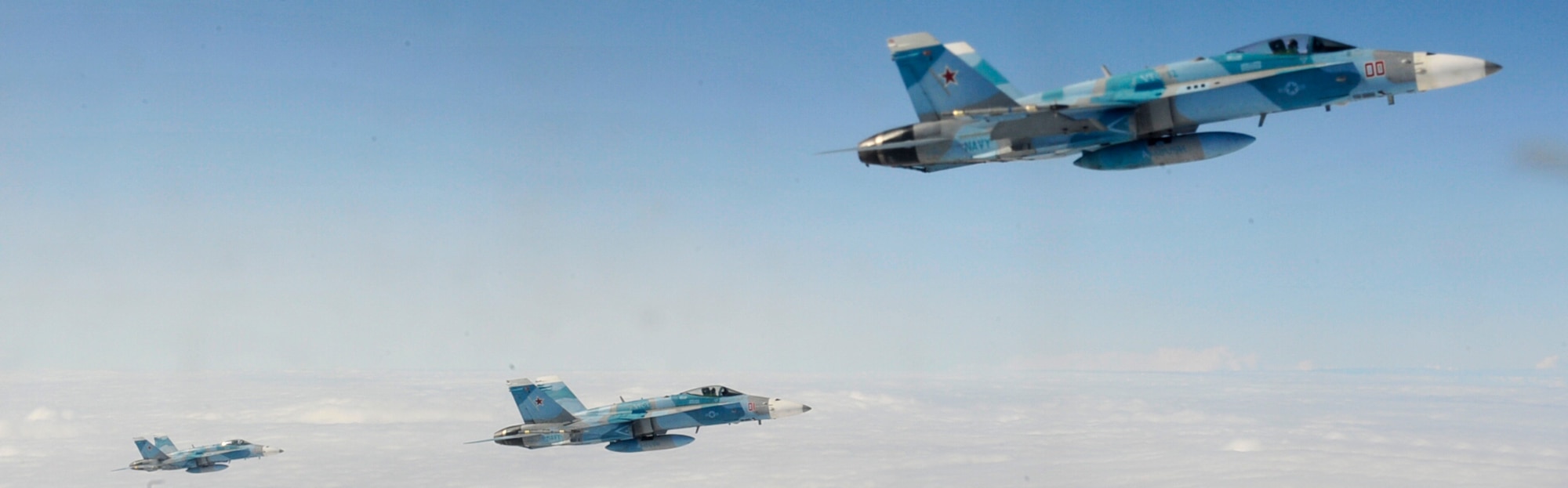 U.S. Navy F-18C Hornets with the "Fighting Omars" of the Fighter Squadron Composite (VFC) 12 from Naval Air Station Oceana, Virginia Beach, Va., receive in-flight refueling from the Marine Aerial Transport Squadron (VMGR) 452, Stewart Air National Guard Base, N.Y., during the Northern Edge Premier Joint Training Exercise at the Joint Alaska Range Complex, June 21. Planning for NE11 began in August of 2010 with exercise experts and planners throughout U.S. Pacific Command and the continental United States. (U.S.  Air Force photo illustration/Staff Sgt. Lakisha A. Croley) 