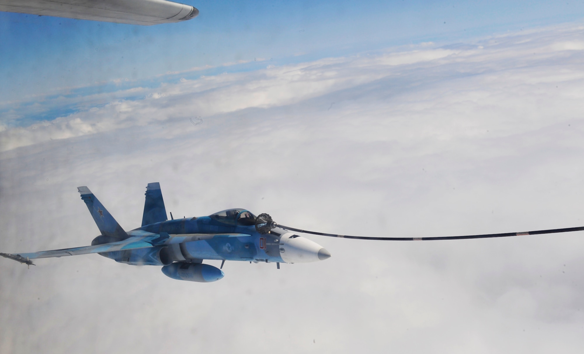 A U.S. Navy F-18C Hornet with the "Fighting Omars?"of the Fighter Squadron Composite (VFC) 12 from Naval Air Station Oceana, Virginia Beach, Va., receives in-flight refueling from the Marine Aerial Transport Squadron (VMGR) 452, Stewart Air National Guard Base, N.Y., during the Northern Edge Premier Joint Training Exercise at the Joint Alaska Range Complex, June 21. Northern Edge is Alaska's largest military training exercise this year. (U.S. Air Force photo/Staff Sgt. Lakisha A.Croley)