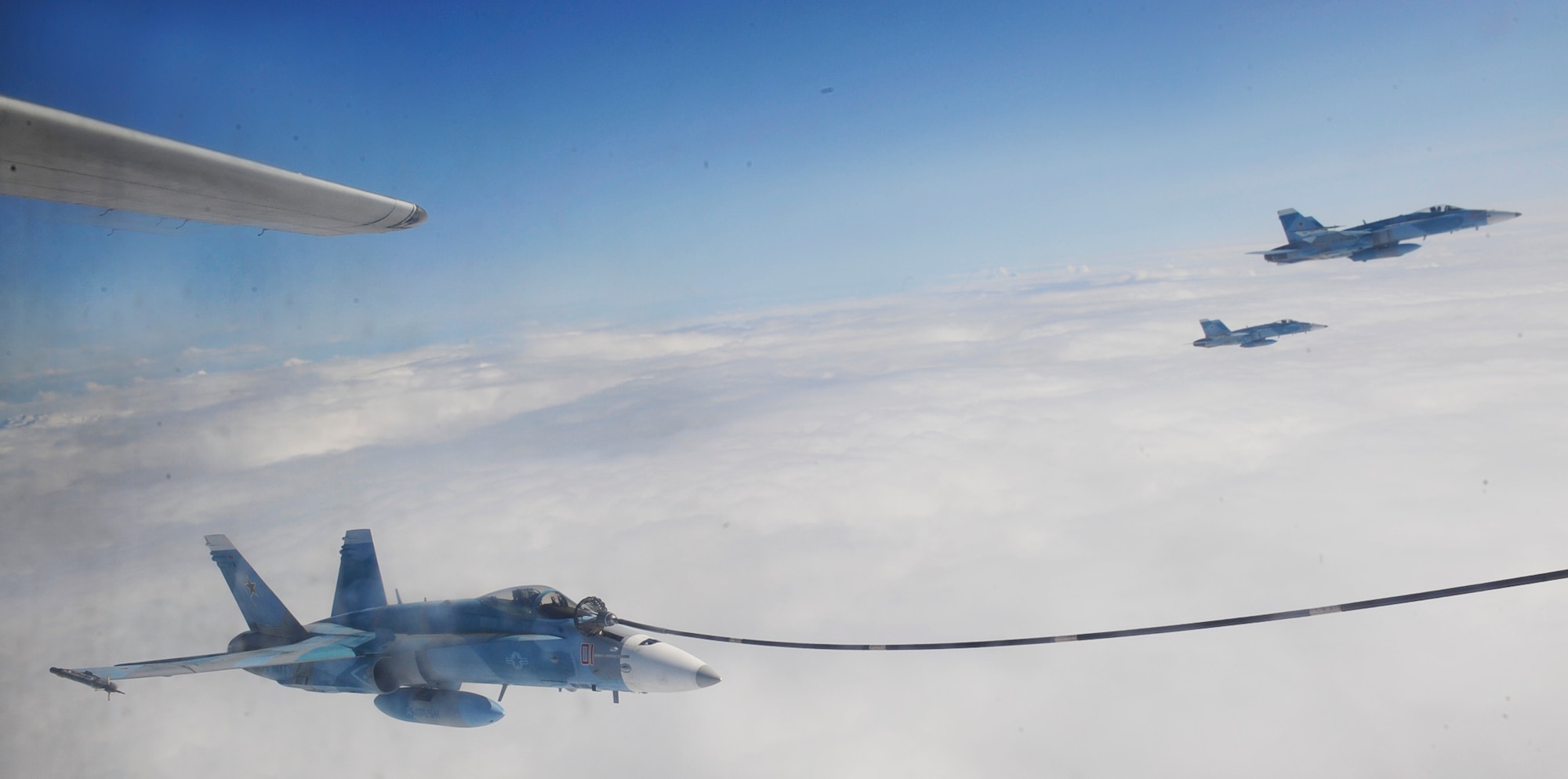 U.S. Navy F-18C Hornets with the "Fighting Omars" of the Fighter Squadron Composite (VFC) 12 from Naval Air Station Oceana, Virginia Beach, Va., receive in-flight refueling from the Marine Aerial Transport Squadron (VMGR) 452, Stewart Air National Guard Base, N.Y., during the Northern Edge Premier Joint Training Exercise at the Joint Alaska Range Complex, June 21. Northern Edge 2011, allows military members to hone existing skills and test future productions of weapon potentials. (U.S. Air Force photo/ Staff Sgt. Lakisha A. Croley)