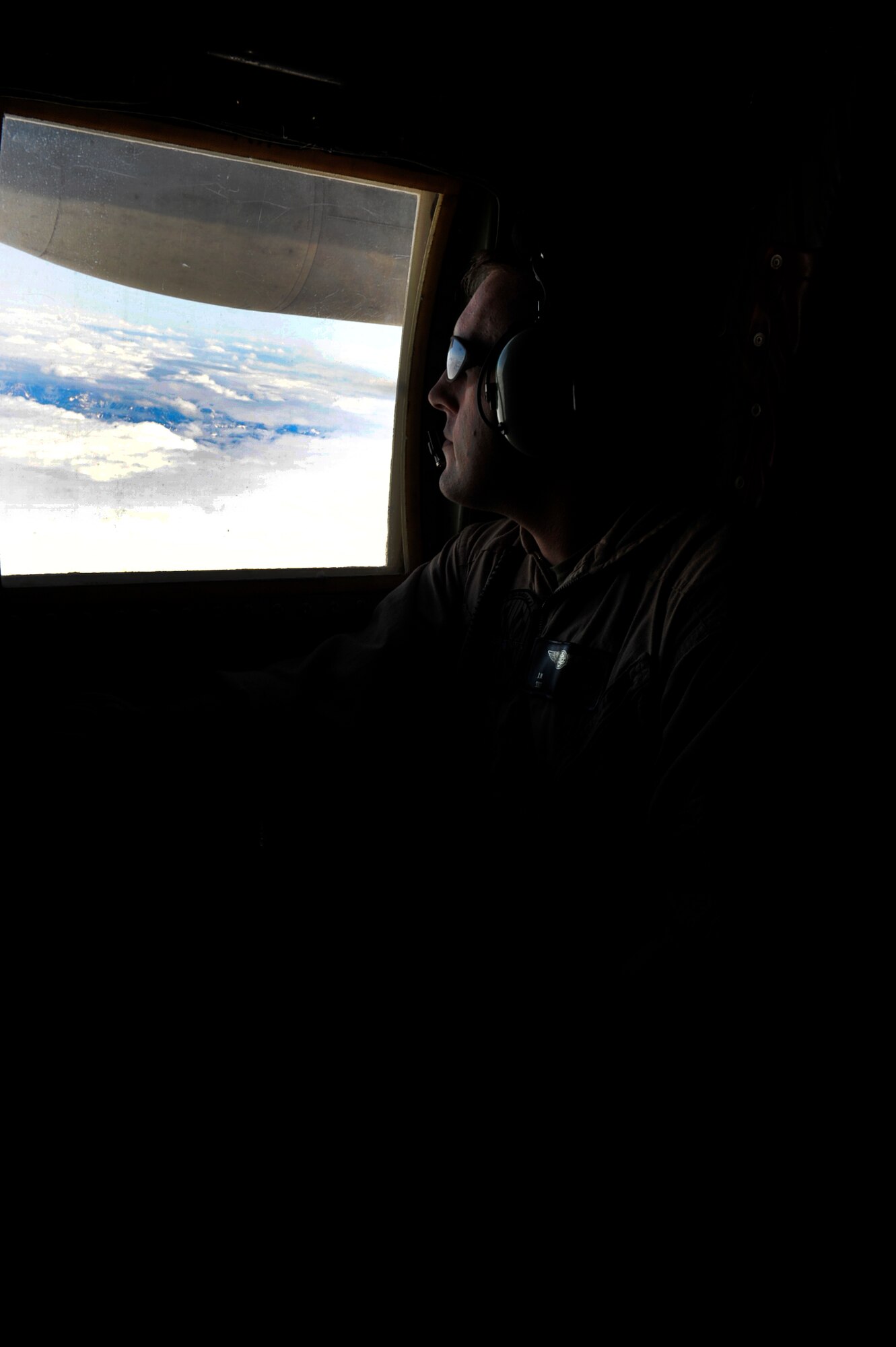 U.S. Marine Corps Sgt. Jason Rudy, a power line shop mechanic with the Marine Aerial Transport Squadron (VMGR) 452, Stewart Air National Guard Base, N.Y., prepares to observe an in-flight refueling while monitoring the tanking of an F-18C Hornet from the "Fighting Omars" of Fighter Squadron Composite (VFC) 12 from Naval Air Station Oceana, Virginia Beach, Va., during the Northern Edge Premier Joint Training Exercise at the Joint Pacific Alaska Range Complex, June 21.  The VFC 12 unit is a Navy Reserve Fighter Squadron that provides training to east coast air wings. (U.S. Air Force photo/ Staff Sgt. Lakisha A. Croley)