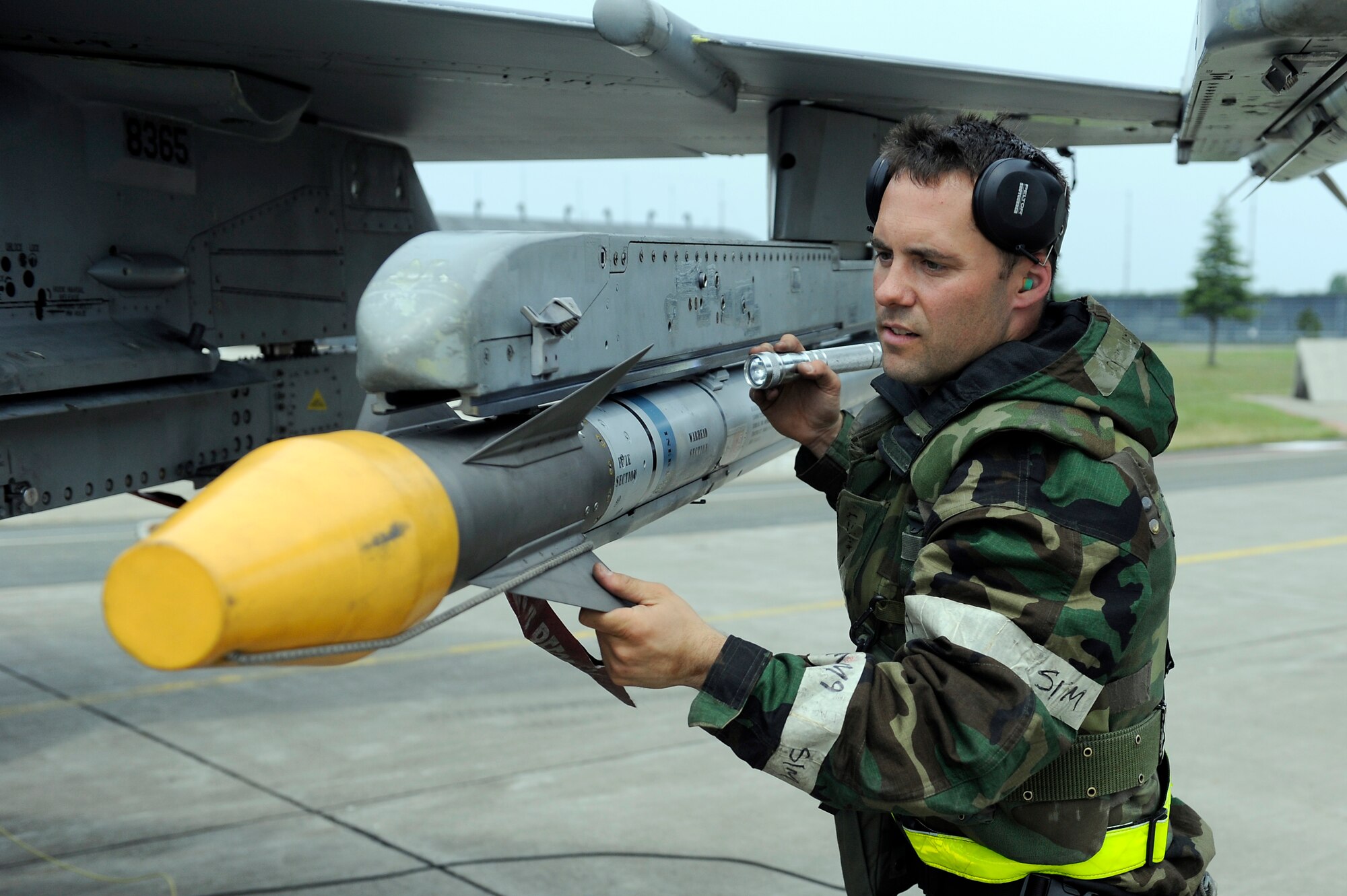MISAWA AIR BASE, Japan -- Staff Sgt. Patrick Cannon, 14th Aircraft Maintenance Unit weapons load team chief, ensures an AIM-9 Sidewinder is secured during a training exercise June 22.  Airmen at Misawa are participating in a week-long exercise designed to test their ability to survive and operate in a combat environment. (U.S. Air Force photo/Staff Sgt. Marie Brown/Released)
