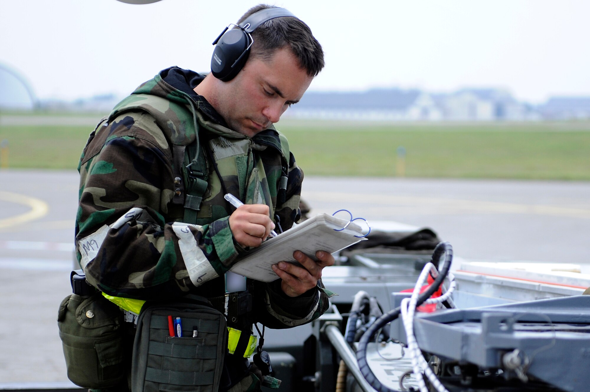 MISAWA AIR BASE, Japan -- Staff Sgt. Patrick Cannon, 14th Aircraft Maintenance Unit weapons load team chief, references a checklist during a training exercise June 22. The 35th Fighter Wing is engaged in a week-long exercise, simulating a variety of scenarios in a combat environment. (U.S. Air Force photo/Staff Sgt. Marie Brown/Released)
