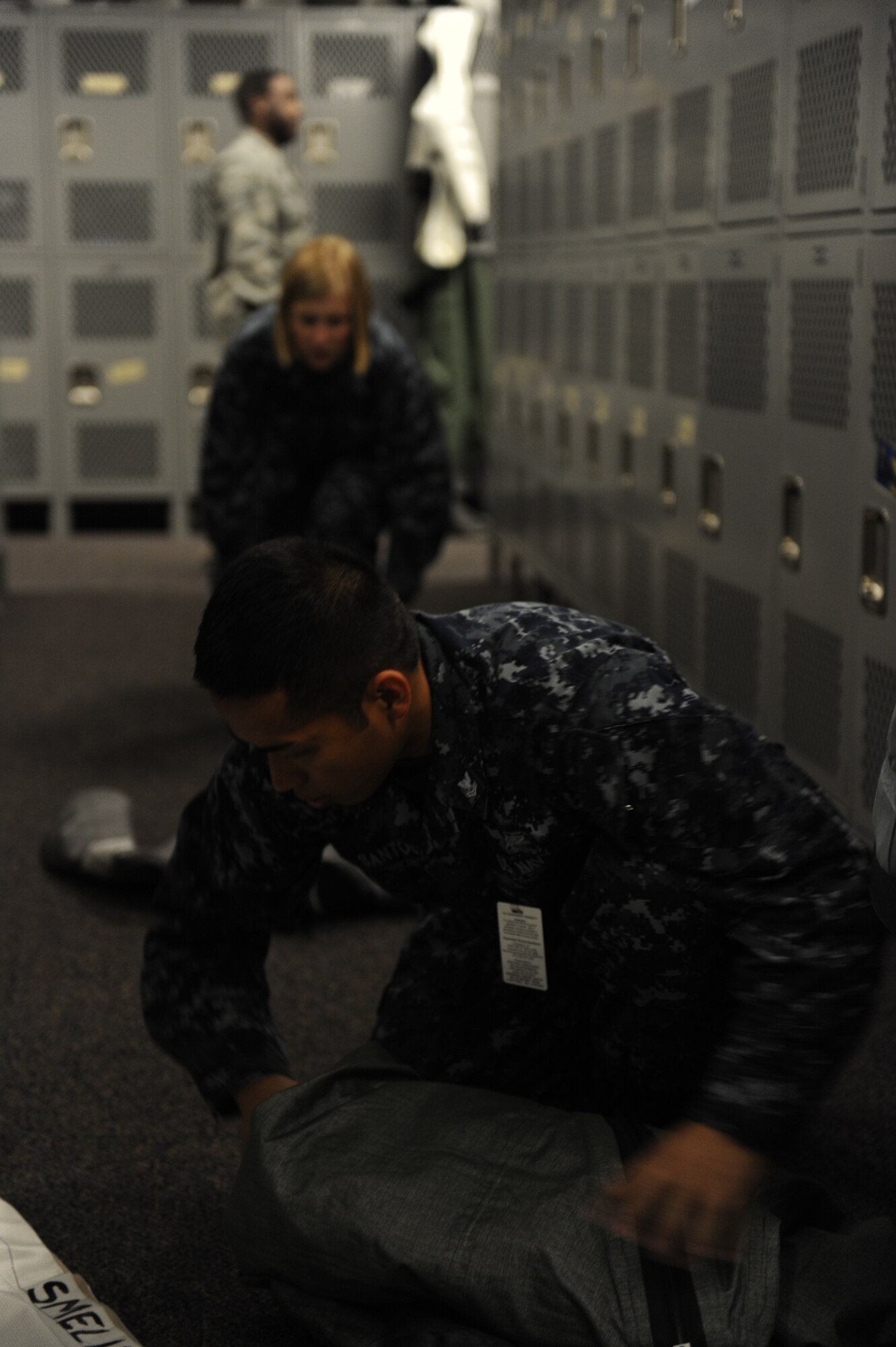 JOINT BASE ELMENDORF RICHARDSON, Alaska -- U.S. Navy Parachute Rigger 2nd Class Nathaniel Santos and Parachute Rigger Airman Jessica Tescher put away pilots gear and prepare the lockers for future flights during Exercise Northern Edge 11, in JBER, Alaska, June 16, 2011. Northern Edge, Alaska's largest military training exercise, is designed to prepare joint forces to respond to crises throughout the Asia-Pacific region. (Photo by Mass Communication Specialist 2nd Class Rufus Hucks)