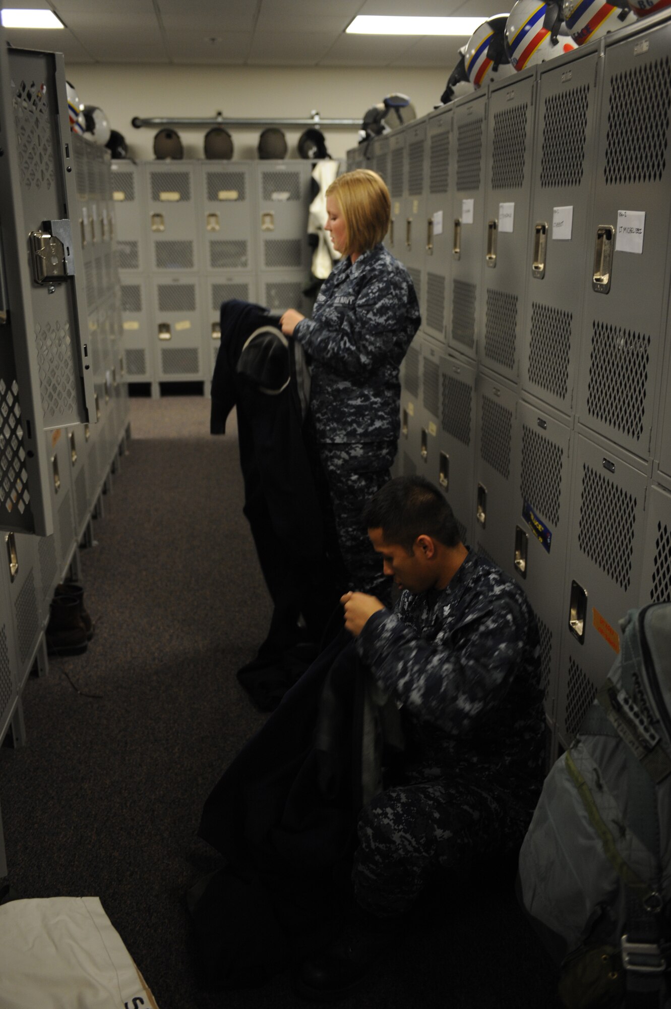 JOINT BASE ELMENDORF RICHARDSON, Alaska -- U.S. Navy Parachute Rigger 2nd Class Nathaniel Santos and Parachute Rigger Airman Jessica Tescher put away pilots gear and prepare the lockers for future flights during Exercise Northern Edge 11, in JBER, Alaska, June 16, 2011. Northern Edge, Alaska's largest military training exercise, is designed to prepare joint forces to respond to crises throughout the Asia-Pacific region. (Photo by Mass Communication Specialist 2nd Class Rufus Hucks)