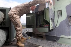 KODIAK, Alaska -- Marine Cpl. Ryan Landis, a generator mechanic assigned to Marine Air Control Squadron-1, 3d Marine Aircraft Wing, performs routine maintenance on a generator at Coast Guard Base Kodiak, Alaska, June 14, 2011, during Exercise Northern Edge 11. (Marine Corps photo/ Cpl. Marionne T. Mangrum)