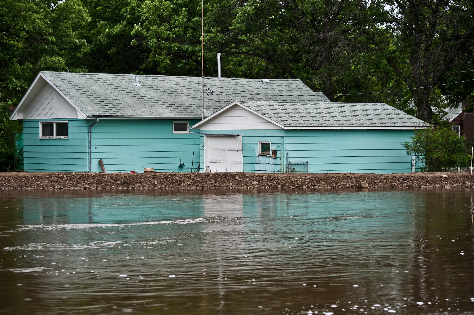 Minot Air Force Base, N.D.—Air Force Global Strike Command Airmen, Minot city officials, the National Guard, and the Corps of Engineers here are preparing for the worst flood in this city’s history. By Monday, June 29, 2011, Mouse River pressures and heights will reach unprecedented levels—seven to ten feet higher than the all time record with pressures reaching approximately 16,000 cubic feet per second. On June 22, 2011 the river, breached the levees and the warning sirens sounded requiring the immediate evacuation of over 11,000 Minot residents. (U.S. Air Force photo/Staff Sgt. John D. Comer)

