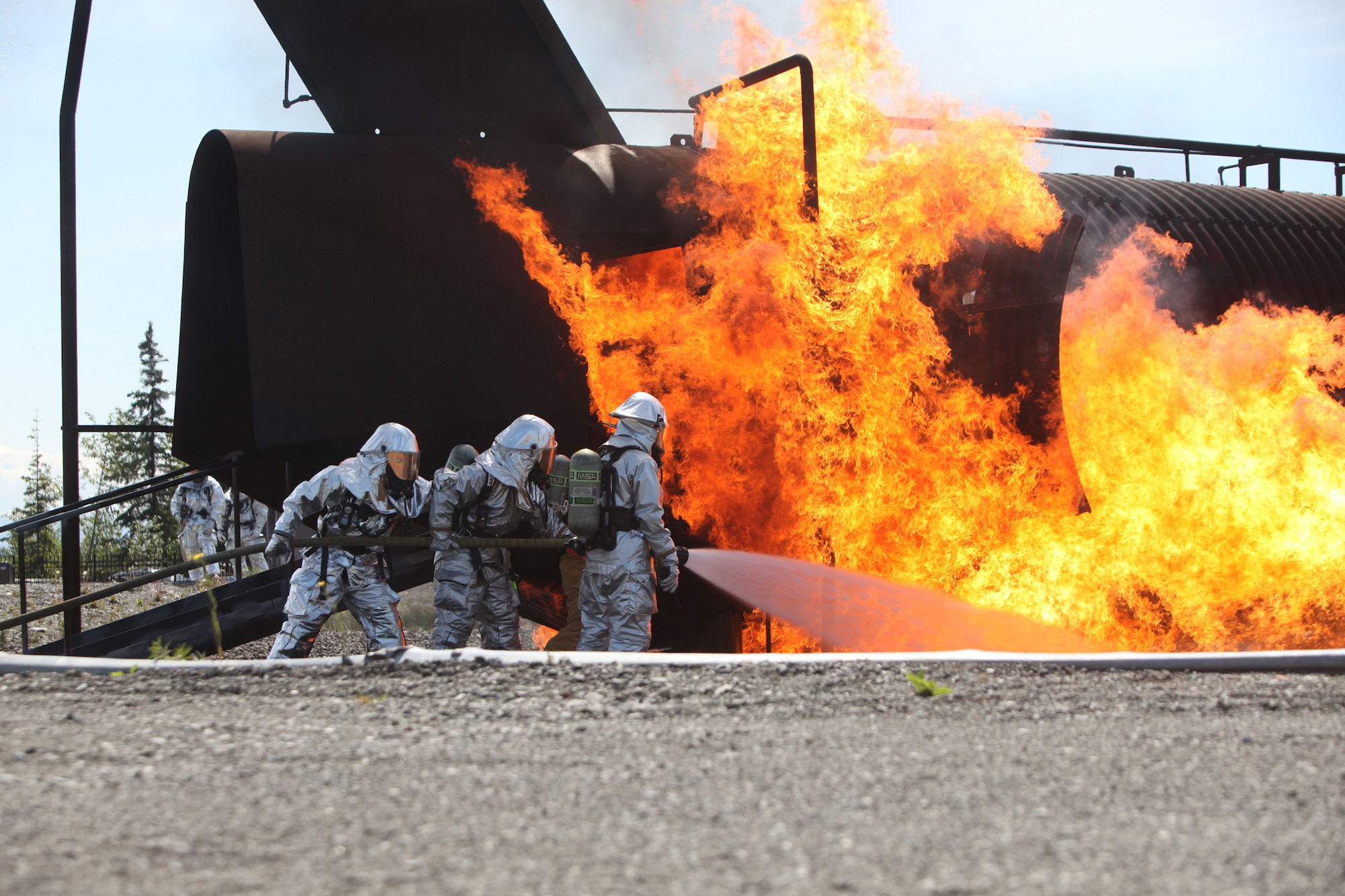 JOINT BASE ELMENDORF-RICHARDSON, Alaska -- Firefighters from the 673rd Civil Engineer Squadron at Joint Base Elmendorf-Richardson complete rescue training June 17, 2011. In addition to maintaining the same training qualifications as civilian firefighters, the Airmen must learn how to rescue aviators from the various aircraft participating in Exercise Northern Edge 11. More than 6,000 servicemembers and 150 aircraft are participating in Alaska's largest military training exercise. (Photo by Marine Cpl. Marionne T. Mangrum)