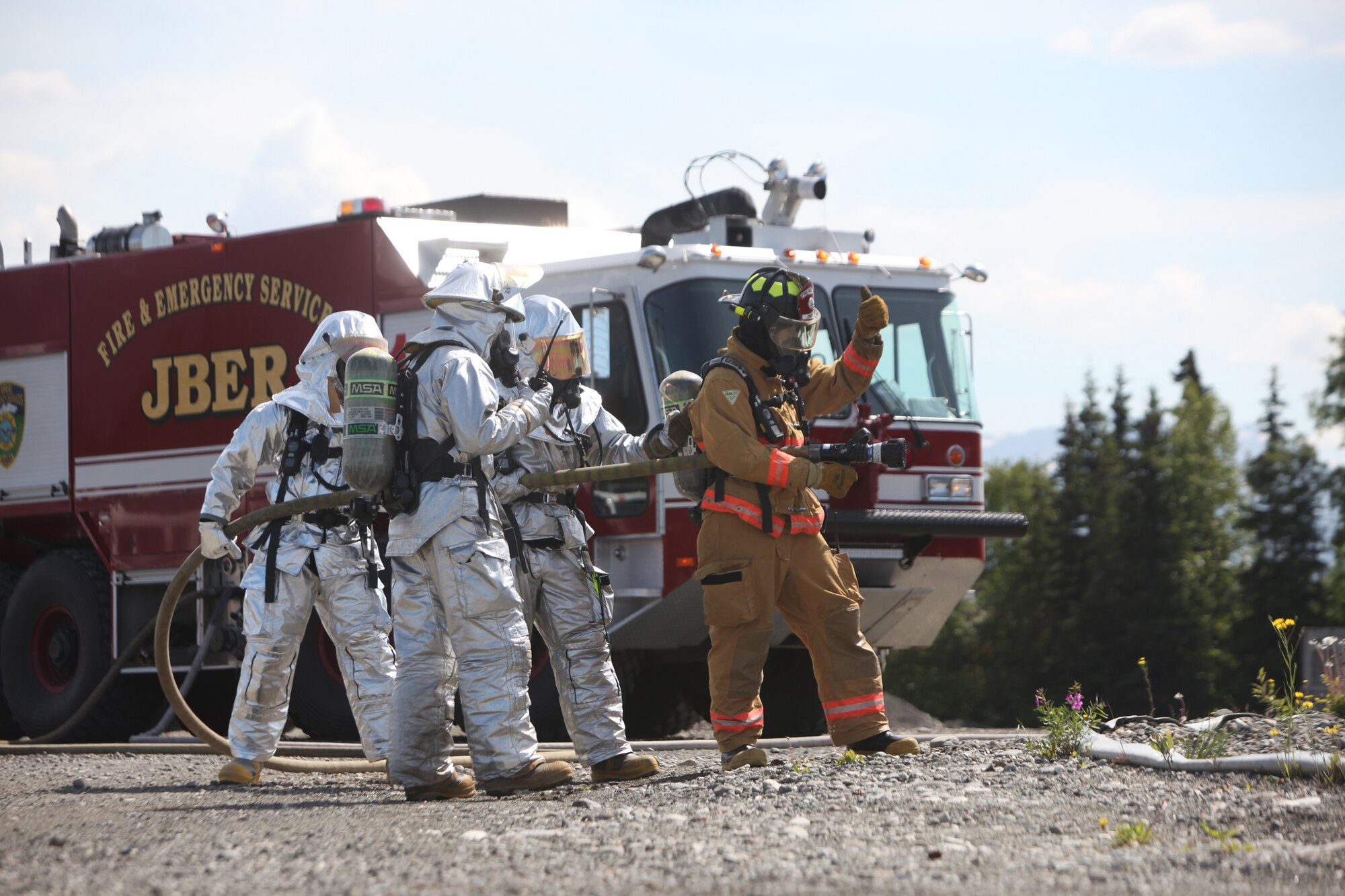 JOINT BASE ELMENDORF-RICHARDSON, Alaska -- Firefighters from the 673rd Civil Engineer Squadron at Joint Base Elmendorf-Richardson complete rescue training June 17, 2011. In addition to maintaining the same training qualifications as civilian firefighters, the Airmen must learn how to rescue aviators from the various aircraft participating in Exercise Northern Edge 11. More than 6,000 servicemembers and 150 aircraft are participating in Alaska's largest military training exercise. (Photo by Marine Cpl. Marionne T. Mangrum)