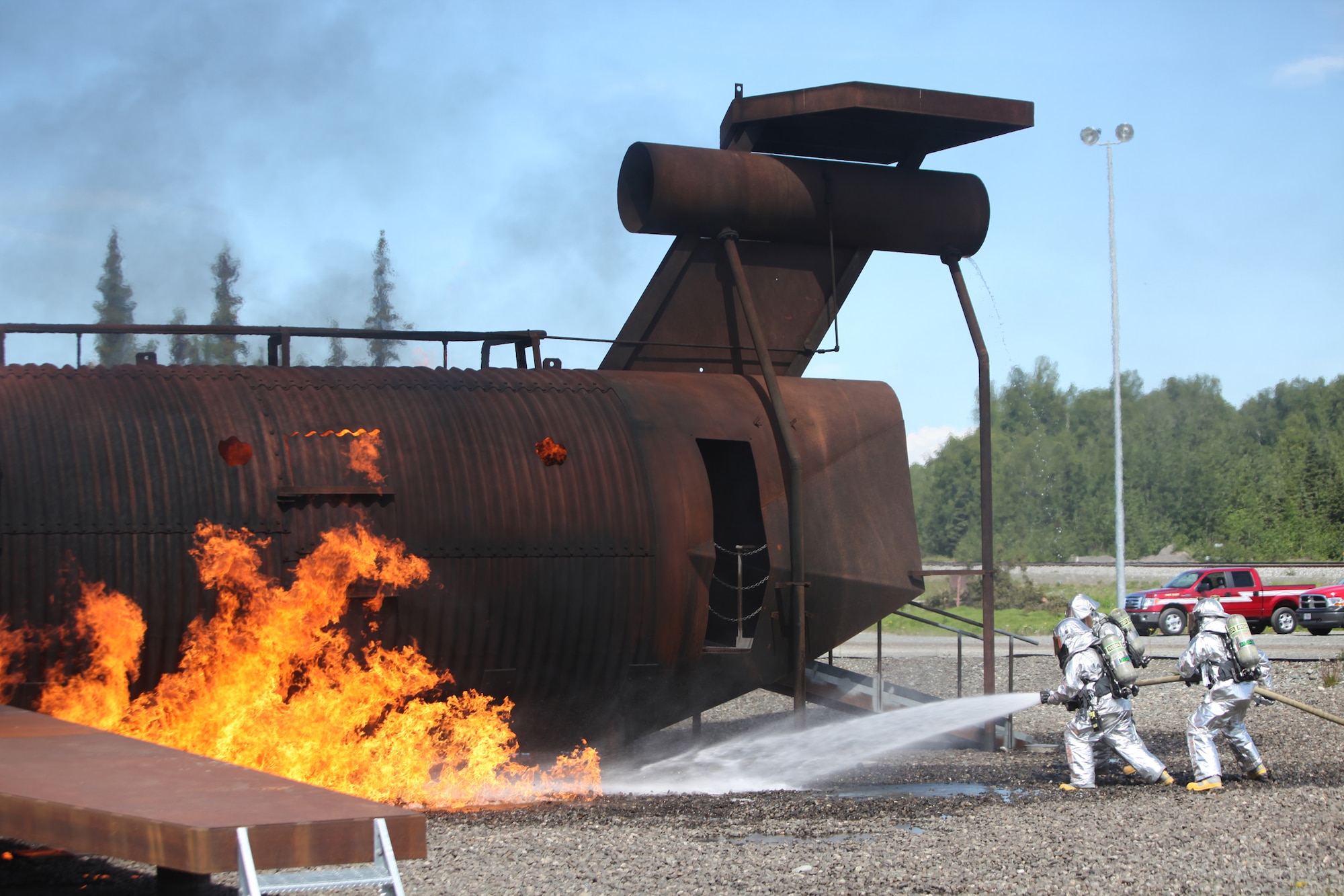 JOINT BASE ELMENDORF-RICHARDSON, Alaska -- Firefighters from the 673rd Civil Engineer Squadron at Joint Base Elmendorf-Richardson complete rescue training June 17, 2011. In addition to maintaining the same training qualifications as civilian firefighters, the Airmen must learn how to rescue aviators from the various aircraft participating in Exercise Northern Edge 11. More than 6,000 servicemembers and 150 aircraft are participating in Alaska's largest military training exercise. (Photo by Marine Cpl. Marionne T. Mangrum)
