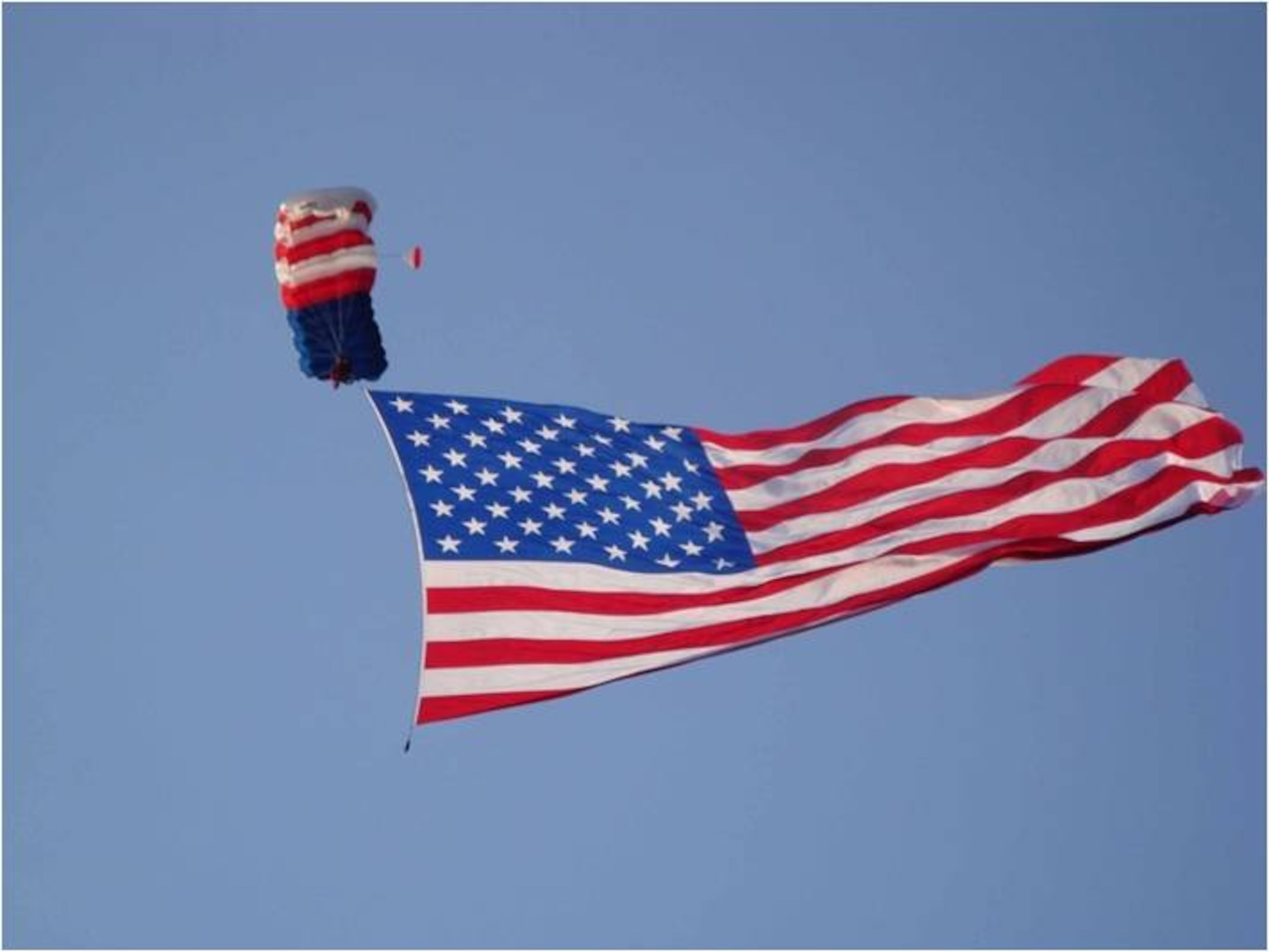 A parachute jumper descends with Old Glory during the opening ceremonies at a past Air Force Materiel Command Freedom’s Call Tattoo.  Attendees at Tattoo 2011 will see similar displays of patriotism as part of the event’s focus on “Defending Liberty…Home and Abroad.”  Tattoo is scheduled for June 24 and will be held on the grounds of the National Museum of the United States Air Force.  The gates open at 4:00 p.m. and the event is free and open to the public. (U.S. Air Force photo)