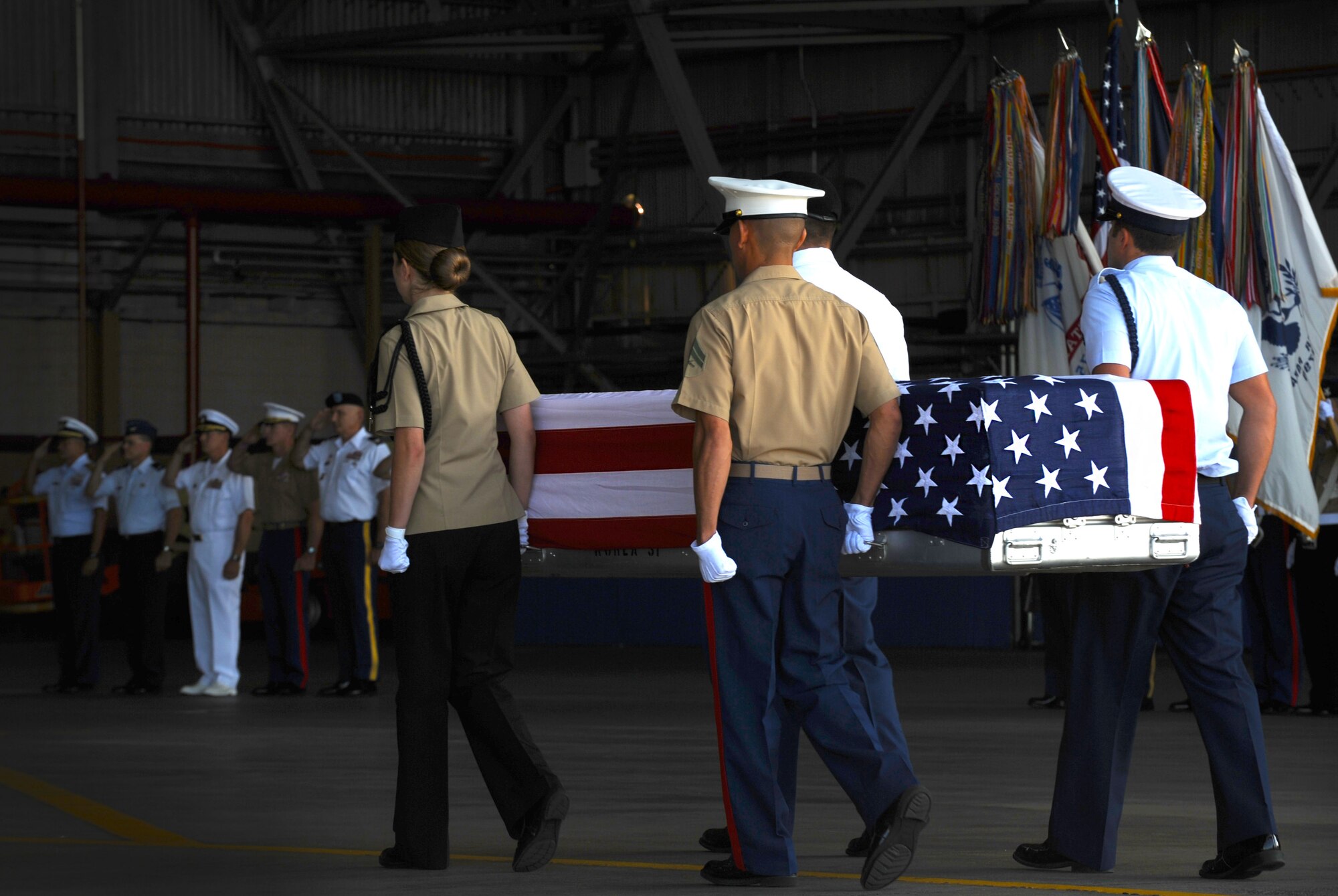 Military members transfer the remains of a U.S. service member June 17, 2011, during an arrival ceremony at Joint Base Pearl Harbor-Hickam, Hawaii.  The unidentified remains were recovered by members of the Joint Pacific Accounting Command. Following the ceremony, with full military honors, the remains were sent to JPAC's Central Identification Laboratory where forensic identification analysis will be conducted so they may be identified and returned to member’s family. (U.S. Air Force photo/Senior Airman Lauren Main) 