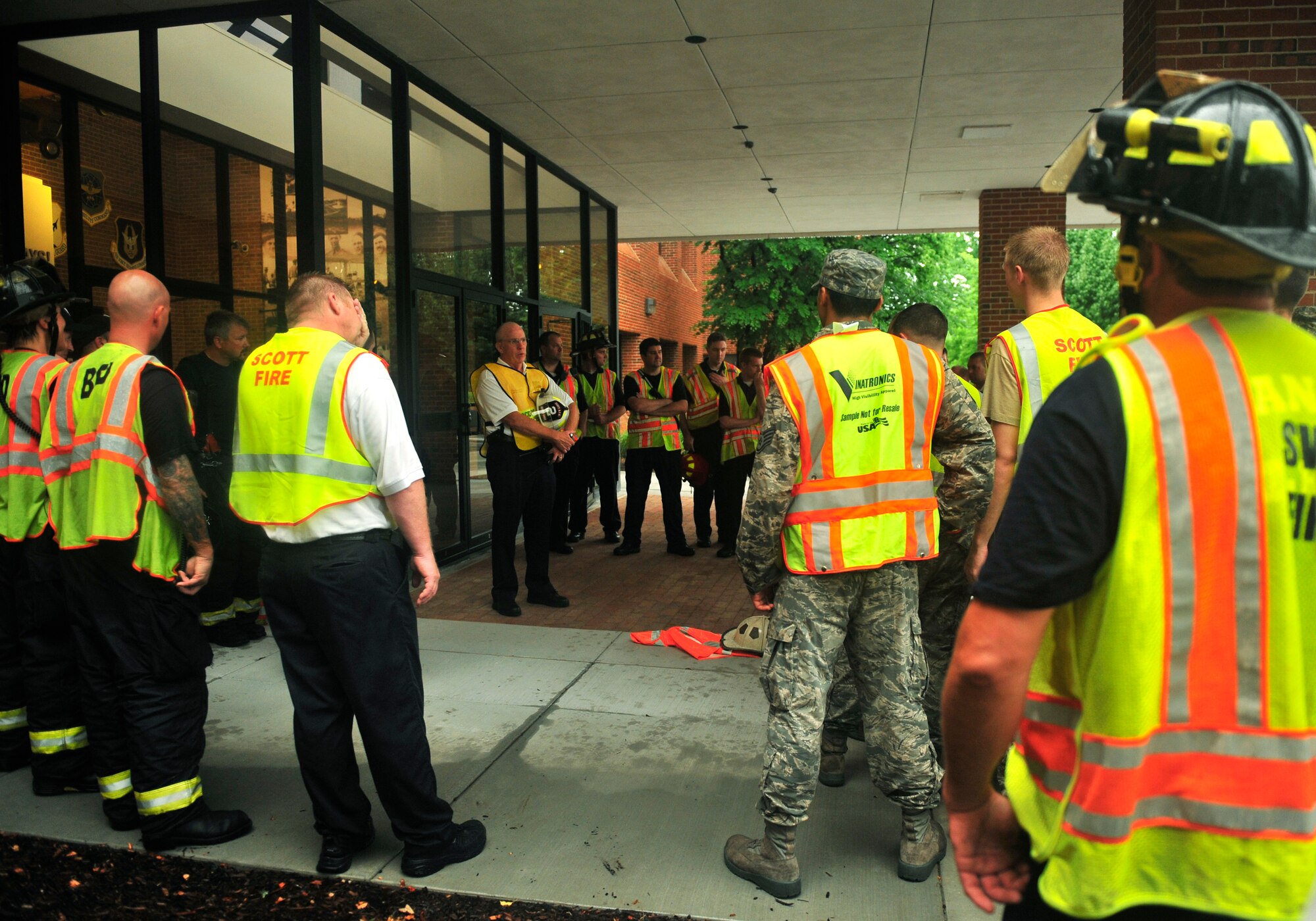 Chief Paul Kempton, acting 375th Civil Engineer Squadron fire chief, debriefs a group of firemen after a training scenario outside of the Air Mobility Command building June 21, 2011. More than 20 firefighters from surrounding off-base fire departments also participated in this scenario. This was the first time a joint fire training scenario was held at the headquarters building.  (United States Air Force photo/ Staff Sgt. Stephenie Wade)