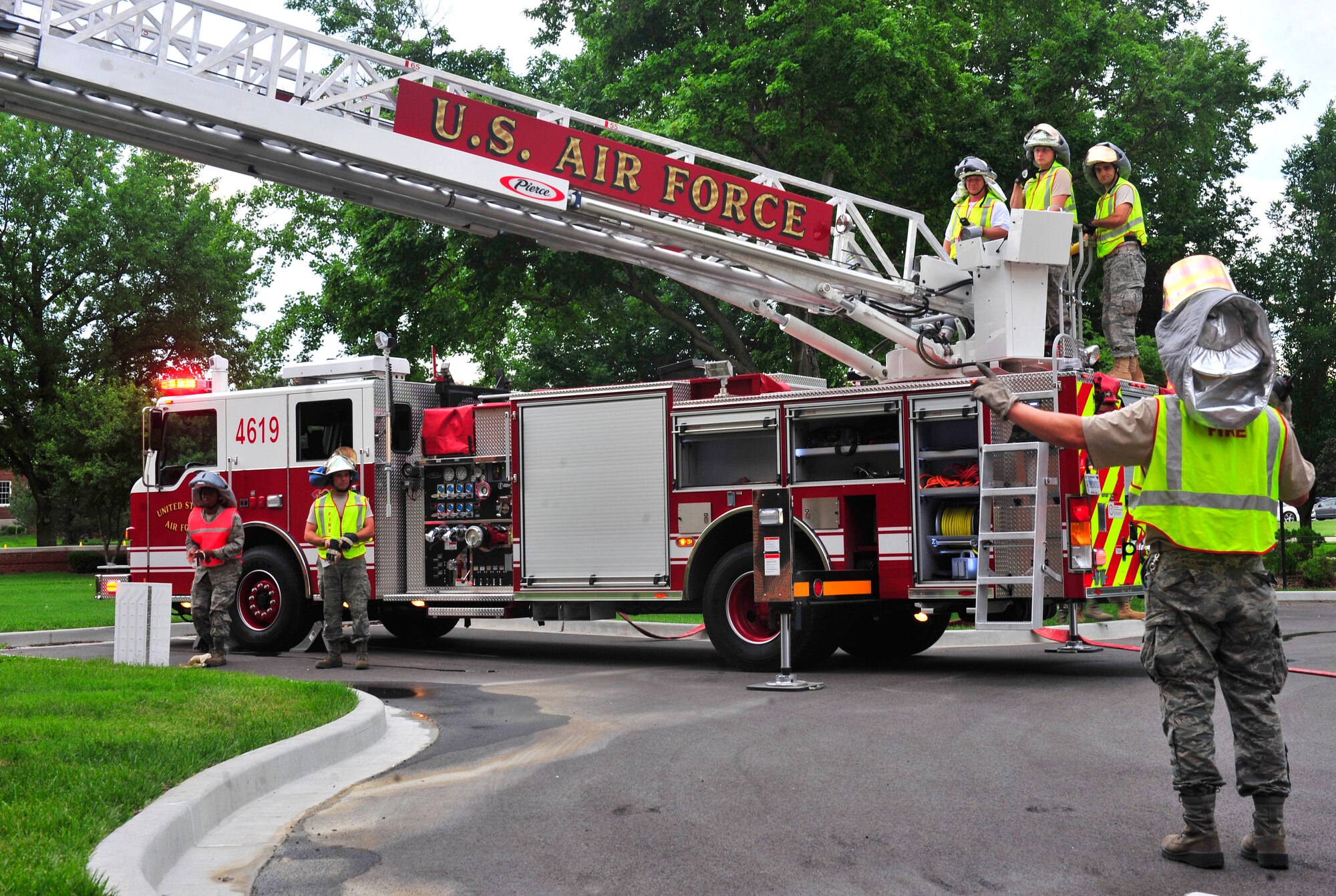 Firefighters from 375th Civil Engineer Squadron raise a turn table ladder over the Air Mobility Command headquarters building June 21, 2011, during a training scenario.  More than 20 firefighters from surrounding off-base fire departments also participated in this scenario. This was the first time a joint fire training scenario was held at the headquarters building.  (United States Air Force photo/ Staff Sgt. Stephenie Wade)