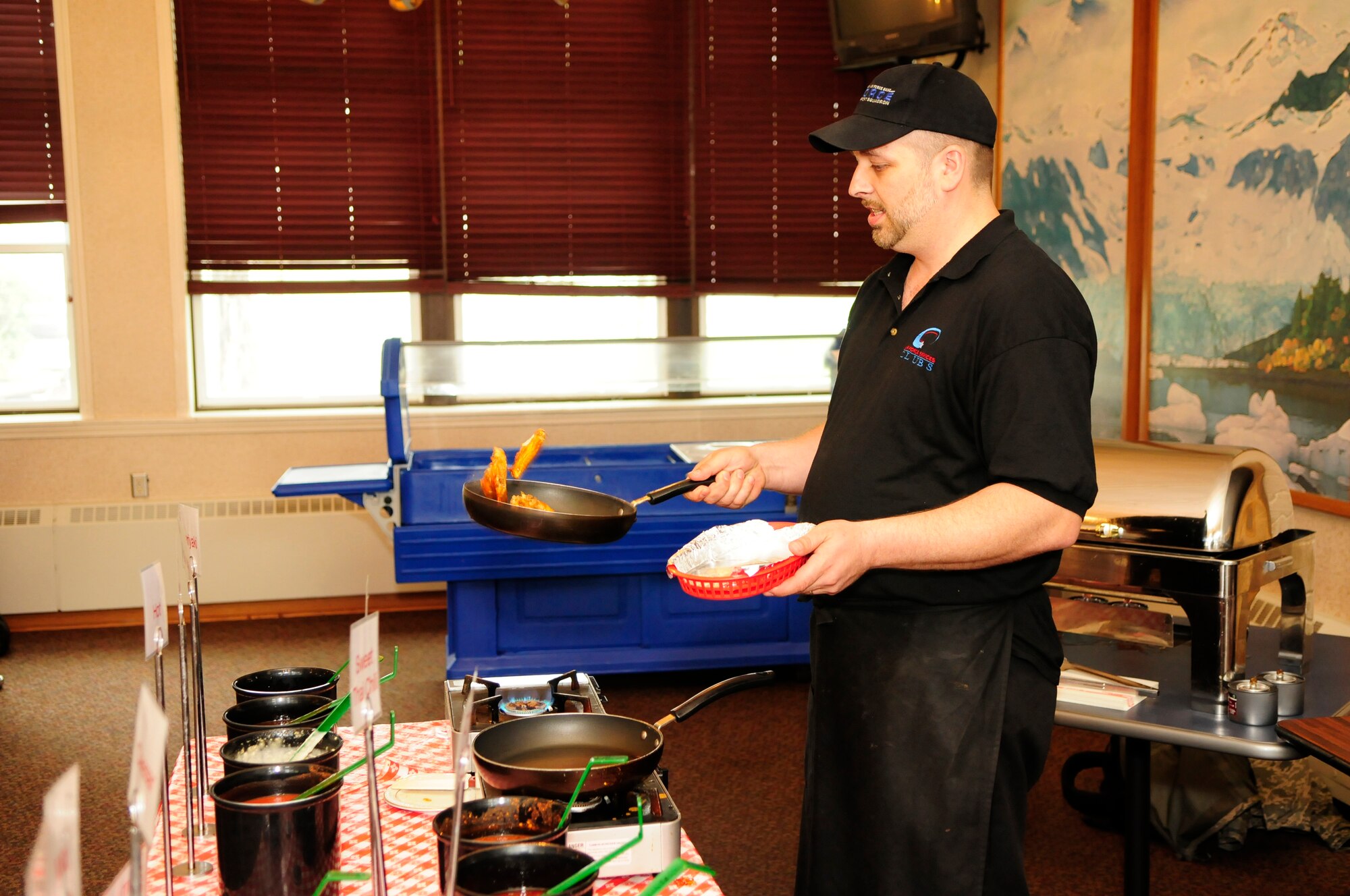 James Clerc prepares a serving of chicken wings June 15, 2011, Eielson Air Force Base, Alaska.  The dynamic environment of Eielson operations and large training exercises, such as NORTHERN EDGE, fuel much of today's success at the Yukon Club.   Mr. Clerc is assigned to the 354th Force Support Squadron.  (U.S. Air Force photo/Airman 1st Class Yash Rojas)
