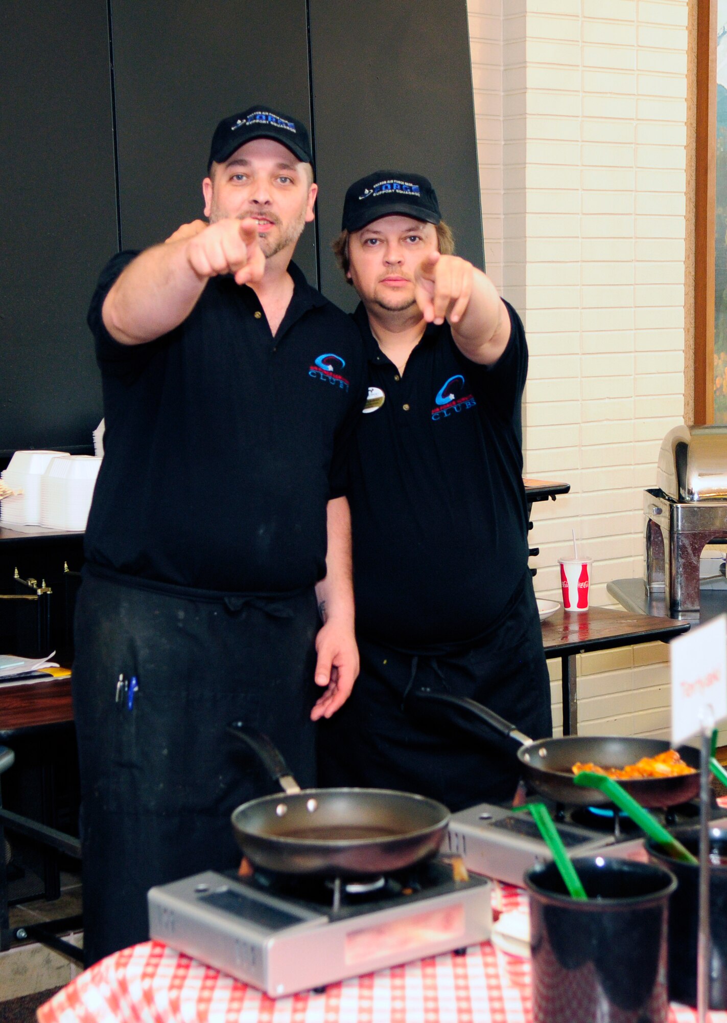 James Clerc and Mike Reardean believe consumers should have more say in what they eat for lunch.  This food concept has drawn numerous customers every week looking for a change in their weekly routine.   Mr. Clerc, kitchen manager, and Mr. Reardean, lead club assistant, both prior military, are assigned to the 354th Force Support Squadron. (U.S. Air Force photo/Airman 1st Class Yash Rojas)