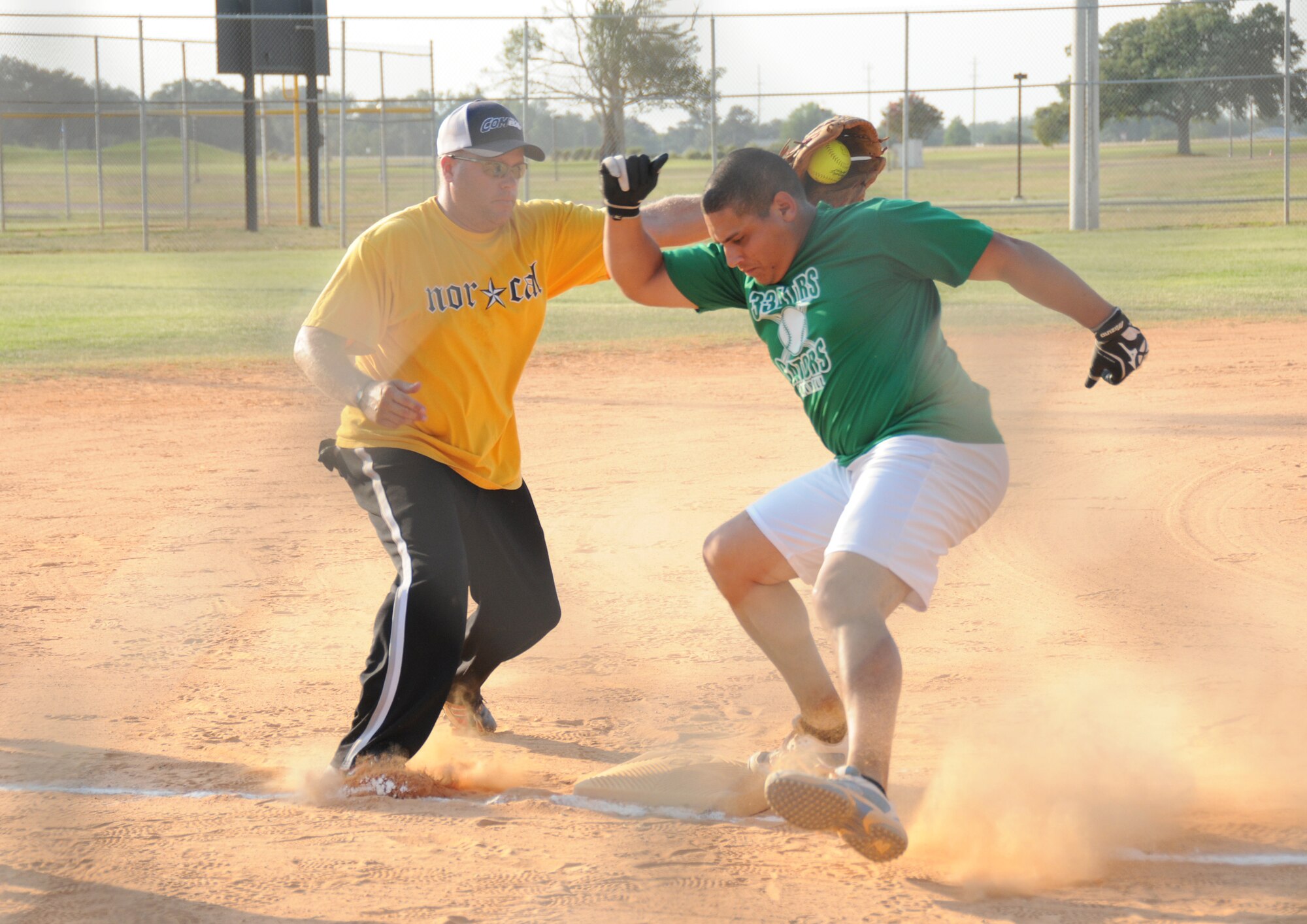 Bulls third baseman Mike Mazza tries to tag out Roberto Lugaro, but Lugaro was called safe in the June 15 intramural softball championship game. The Gators
slipped past the Bulls, 16-15.  (U.S. Air Force photo by Kemberly Groue)