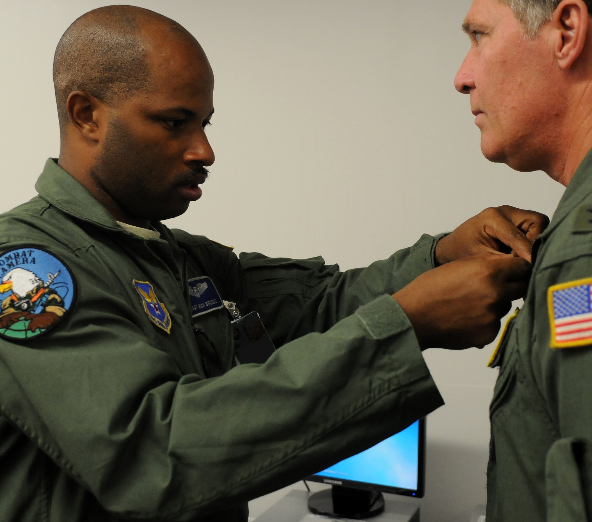 Tech. Sgt. Nick Brooks attaches a microphone to an interviewee June 20, 2011, Eielson Air Force Base, Alaska. The NORTHERN EDGE 2011 Joint Information Bureau is comprised of photographers, journalists and broadcasters from the U.S. Army, Air Force and Navy. Sergeant Brooks is an aerial combat broadcaster assigned to the 1st Combat Camera Squadron, Charleston Air Force Base, South Carolina. (U.S. Air Force photo/Senior Airman Rachelle Coleman)