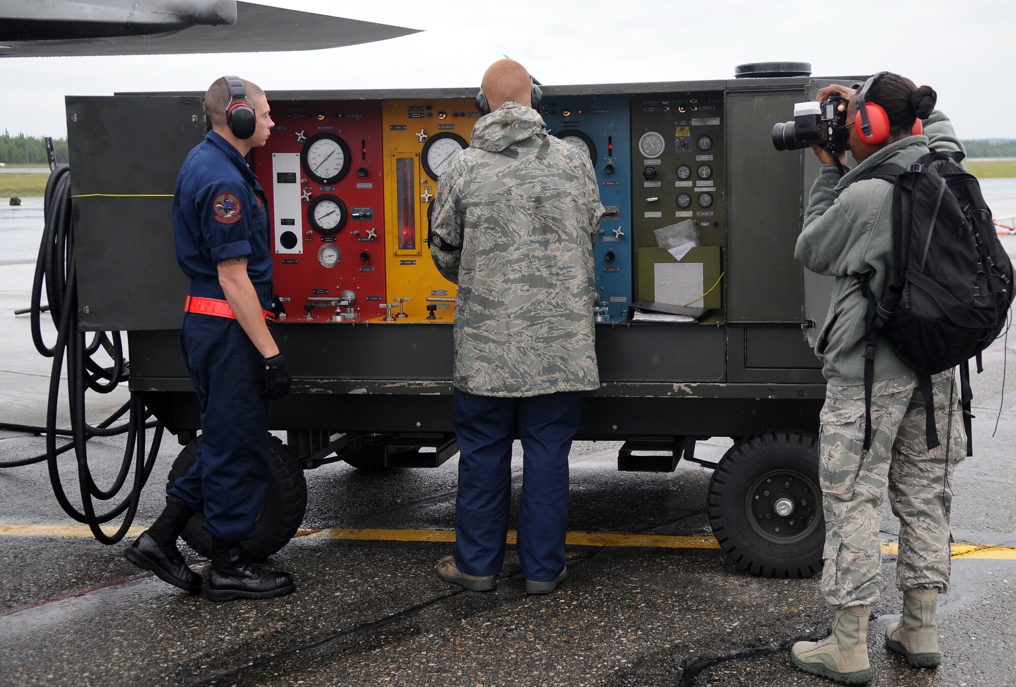 Staff Sgt. Lakisha Croley takes photos of aircraft maintainers working on an F-15E Strike Eagle June 20, 2011, Eielson Air Force Base, Alaska. Public Affairs Airmen working in the Joint Information Bureau provide print, photo and video documentation and publication of operations during NORTHERN EDGE 2011. Sergeant Croley is a photographer assigned to the 18th Wing Public Affairs, Kadena Air Base, Japan. (U.S. Air Force photo/Senior Airman Rachelle Coleman)