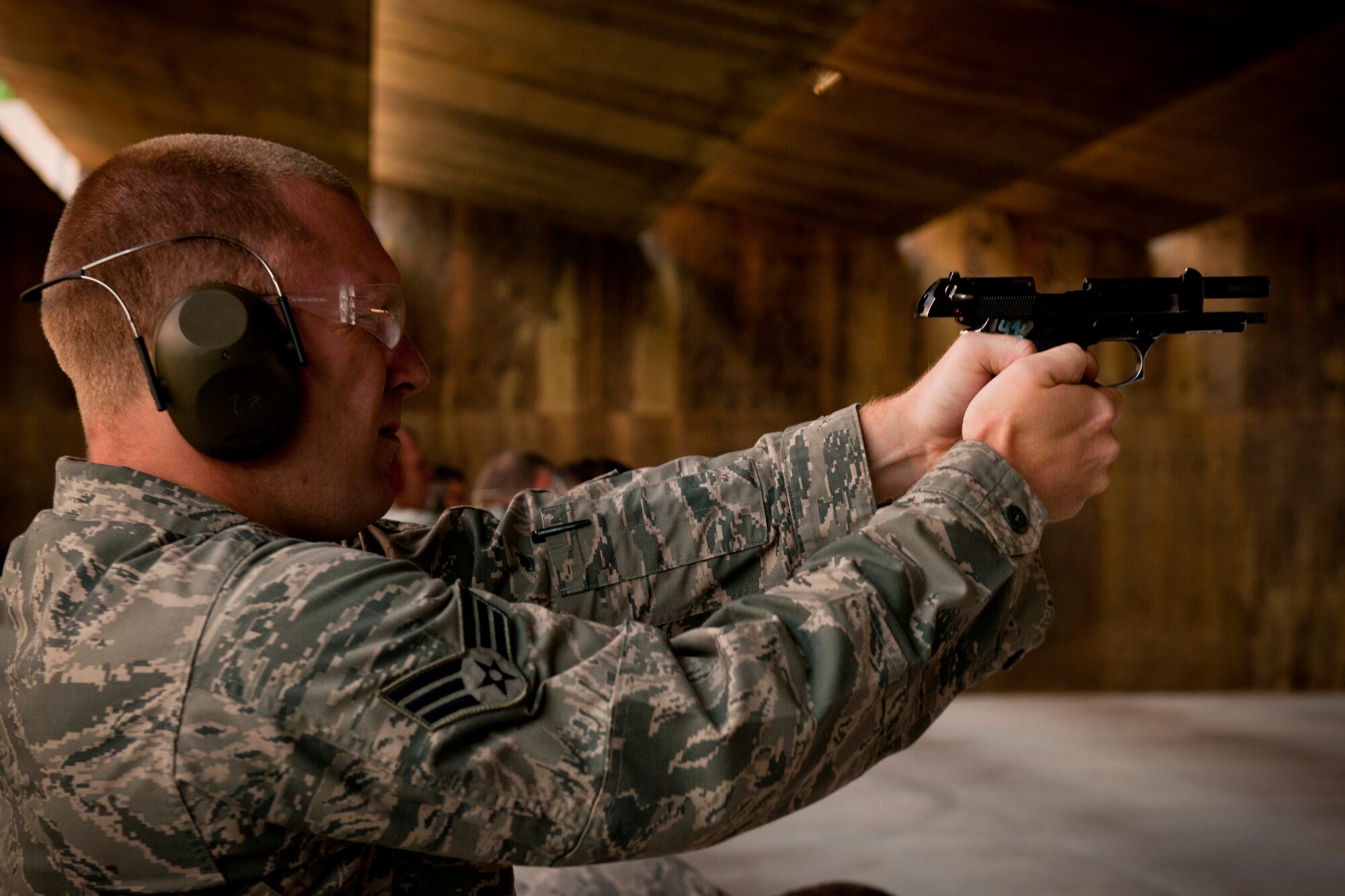 U.S. Air Force Senior Airman John Rheaume, 23rd Civil Engineer Squadron electrician assistant, fires a Beretta M9 pistol during the Excellence In Competition Shooting event at Moody Air Force Base, Ga., June 21, 2011. This was Airman Rheaume’s first time competing in this event. (U.S. Air Force photo by Airman 1st Class Joshua Green/Released)           