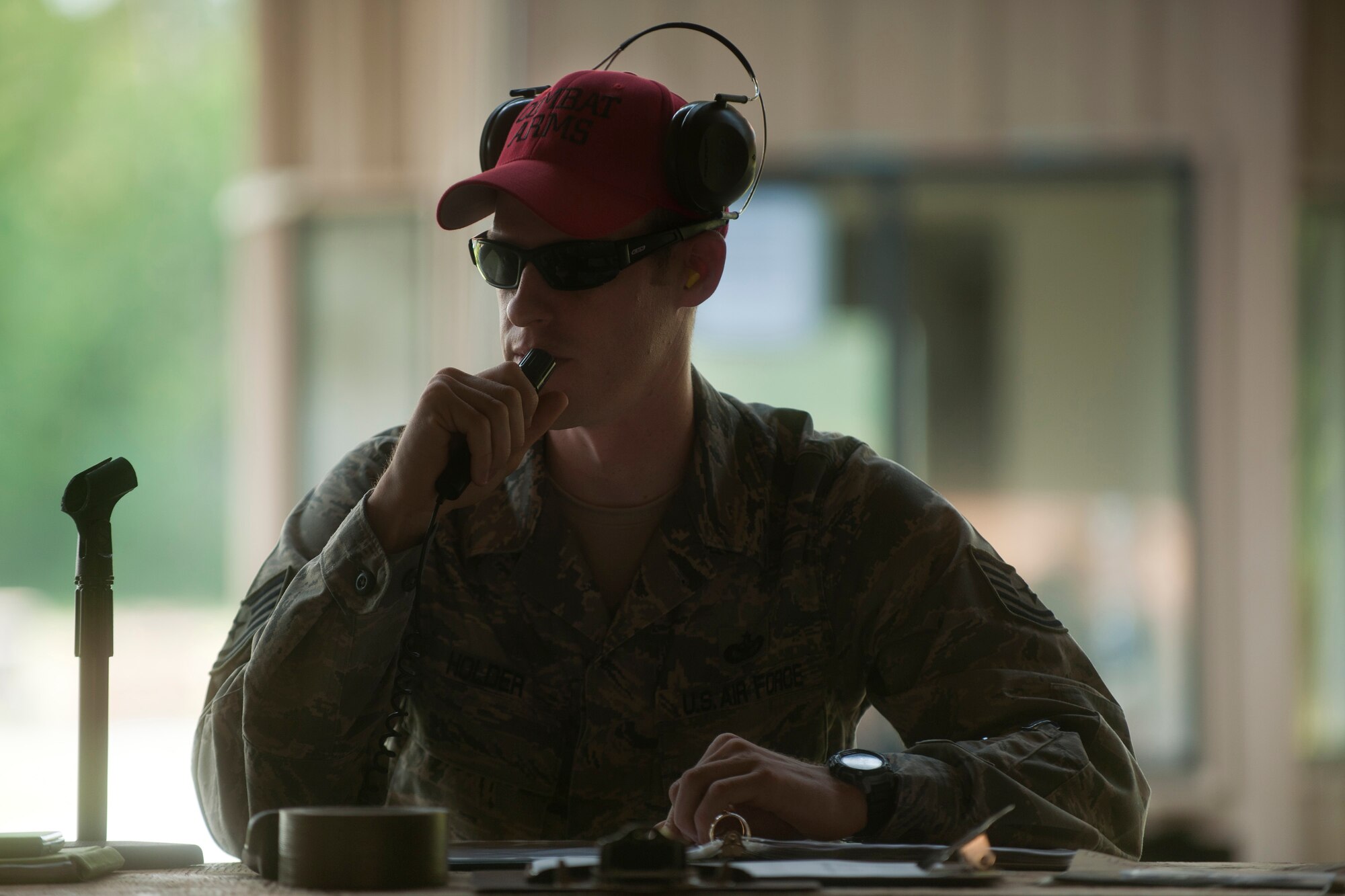 U.S. Air Force Tech. Sgt. Grant Holder, 820th Combat Operations Squadron combat arms instructor, sits behind the control tower and gives shooting instructions to Airmen participating in the Excellence In Competition Shooting event at Moody Air Force Base, Ga., June 21, 2011. A total of 160 Airmen participated in the three-day competition. (U.S. Air Force photo by Airman 1st Class Joshua Green/Released)  