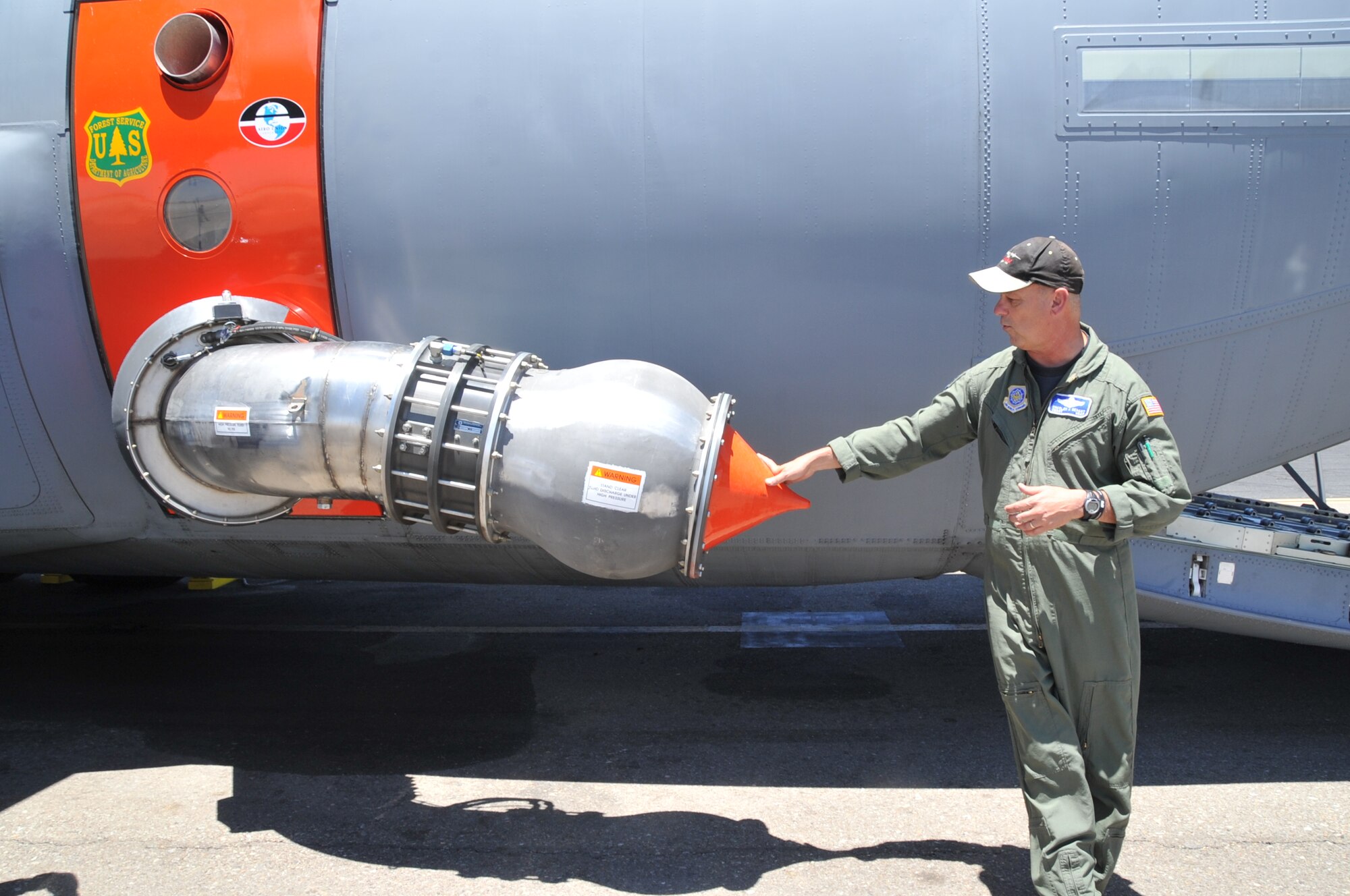 KIRTLAND AIR FORCE BASE, N.M. -- Chief Master Sgt. Jimmy Dehart, 115th Air Expeditionary Airlift Squadron chief loadmaster, California Air National Guard, Channel Islands Air National Guard Station, Calif., explains a Modular Airborne Fire Fighting System’s pintle valve that disperses the water or retardant used to fight wildfires. In support of the National Interagency Fire Center, the unit brought two C-130J aircraft equipped with MAFFS to help control wildfires in the Southwestern U.S. (Air Force photo by Elizabeth Martinez.)